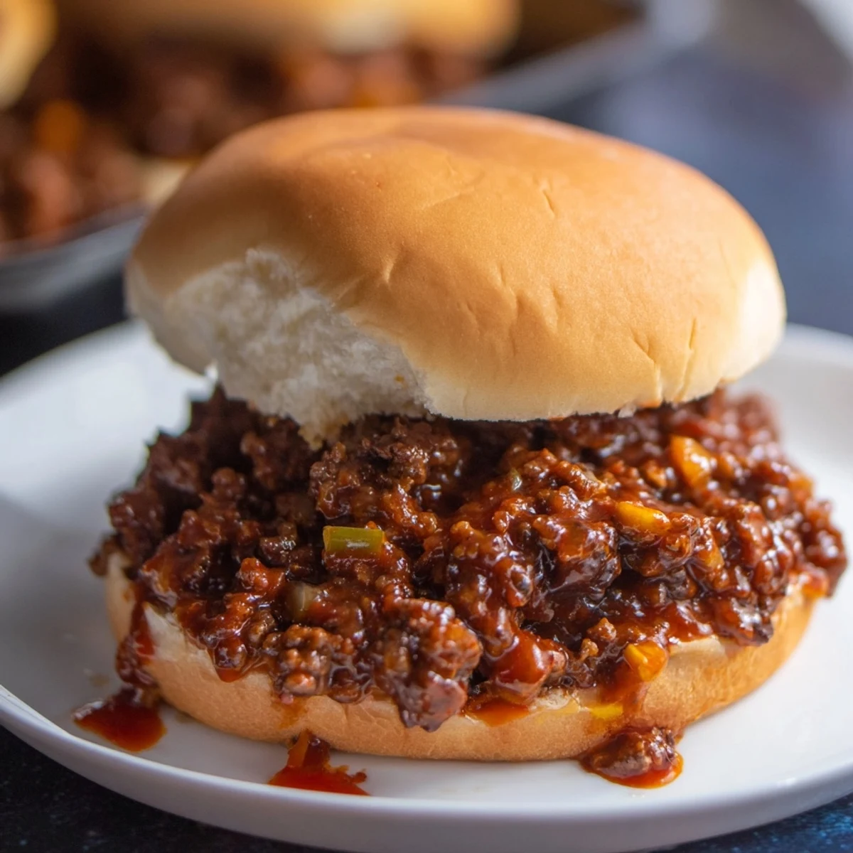 Savory homemade sloppy joes piled high on toasted hamburger buns with melted beef
