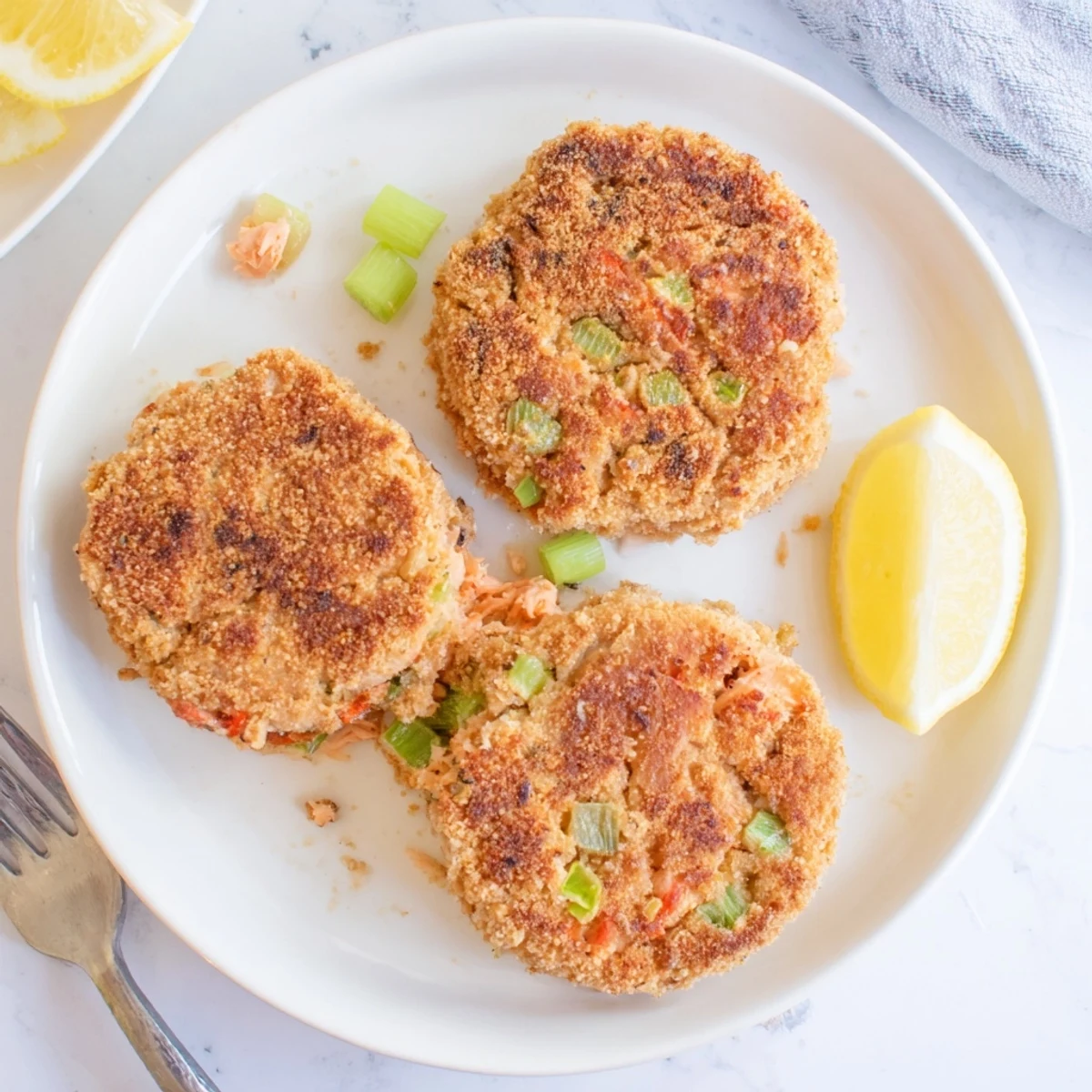 Classic Southern salmon croquettes with golden crust served alongside lemon wedges and tartar sauce