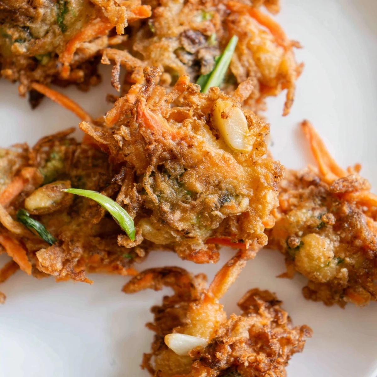 Ukoy Filipino shrimp fritters sizzling in hot oil with julienned vegetables and bean sprouts