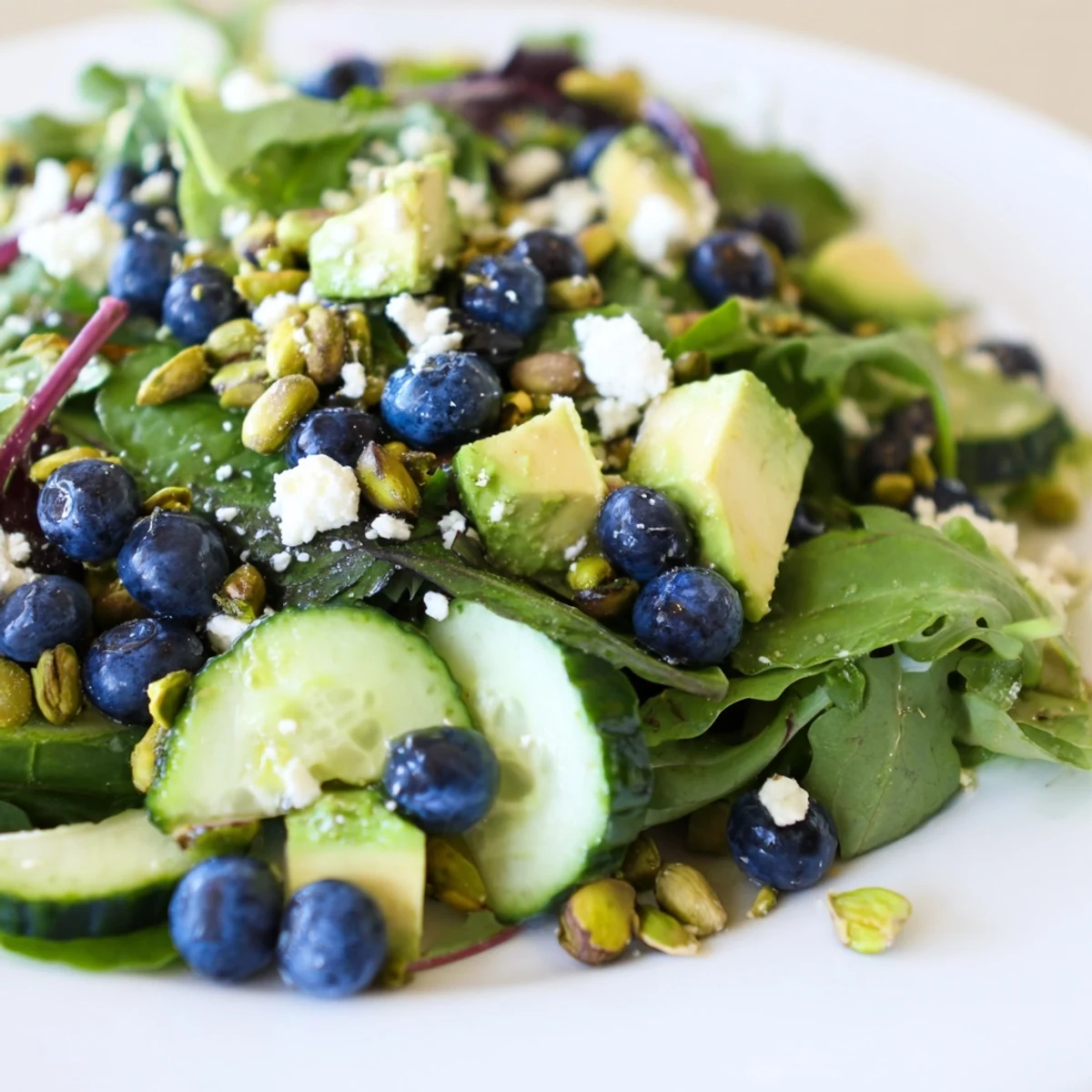 Vibrant Blueberry Pistachio Spring Salad served in a rustic bowl with crisp spring greens