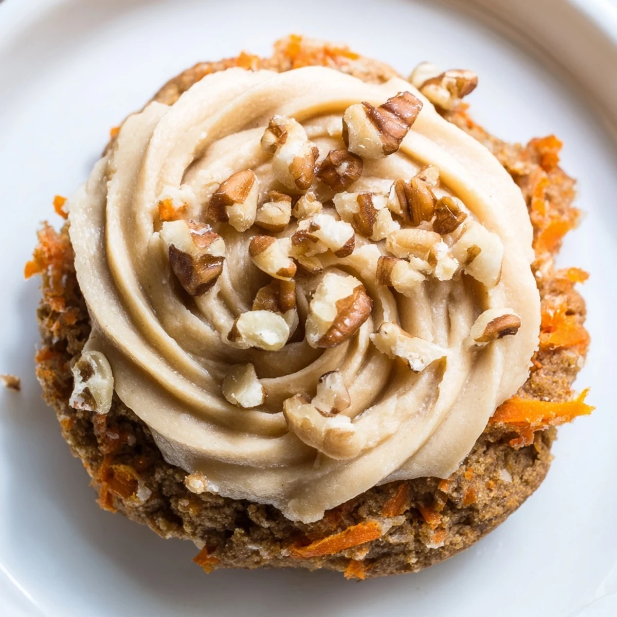 Soft Crumbl carrot cake cookies piled high with tangy cream cheese frosting on a rustic baking sheet