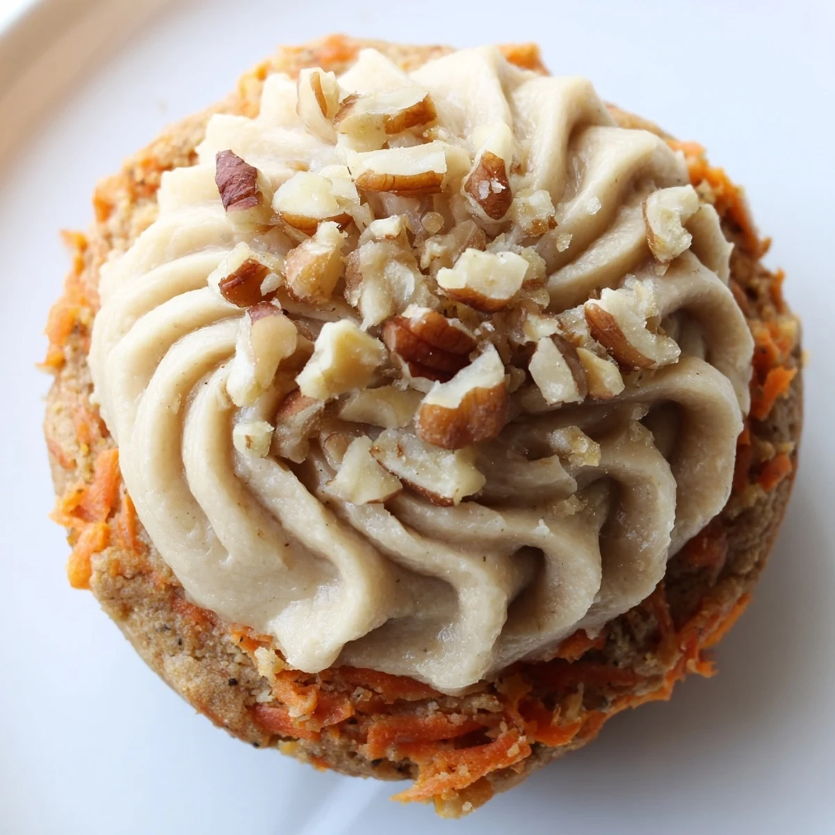 Chewy Crumbl carrot cake cookies topped with generous clouds of sweet vanilla cream cheese frosting