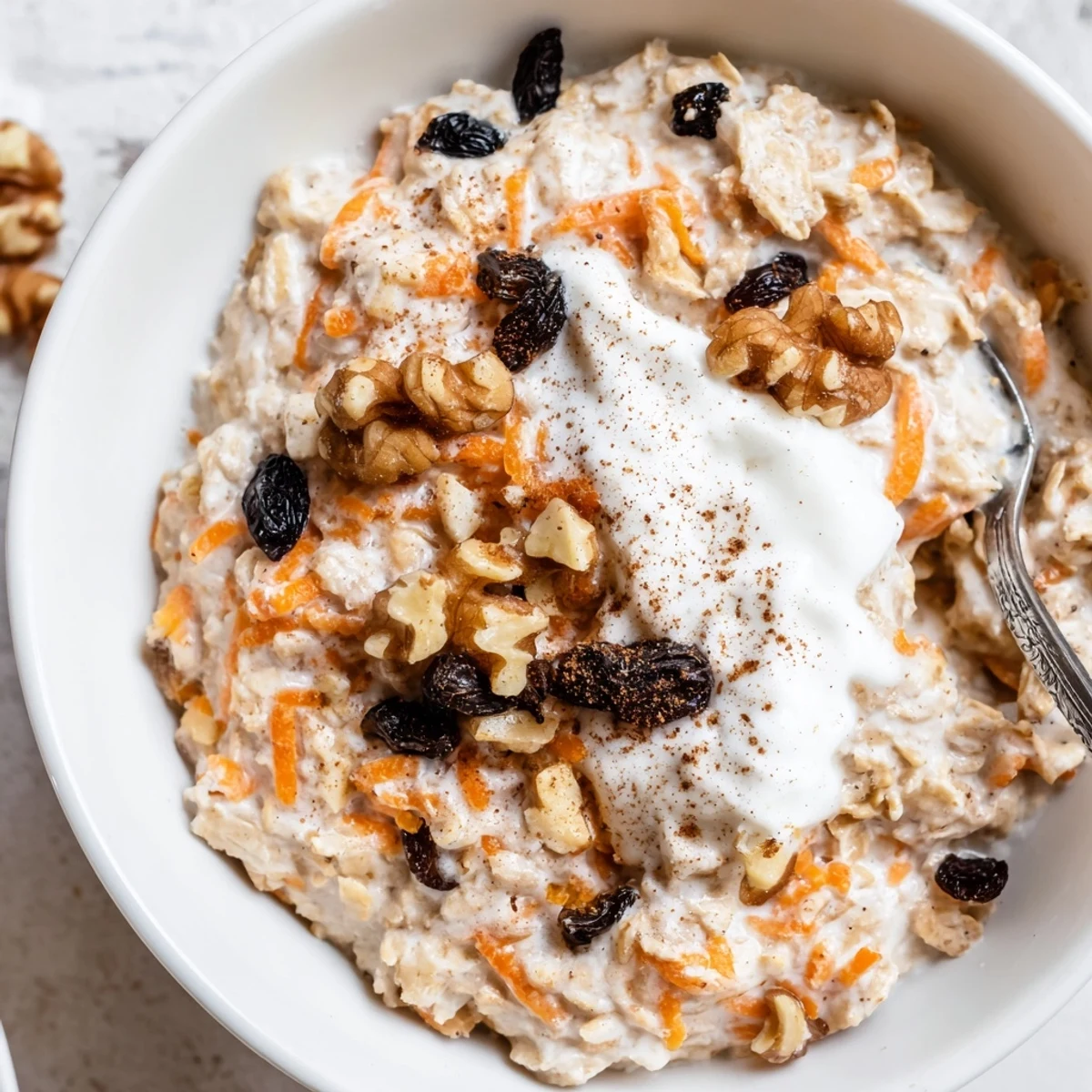 Creamy carrot cake overnight oats topped with crunchy walnuts in a glass jar