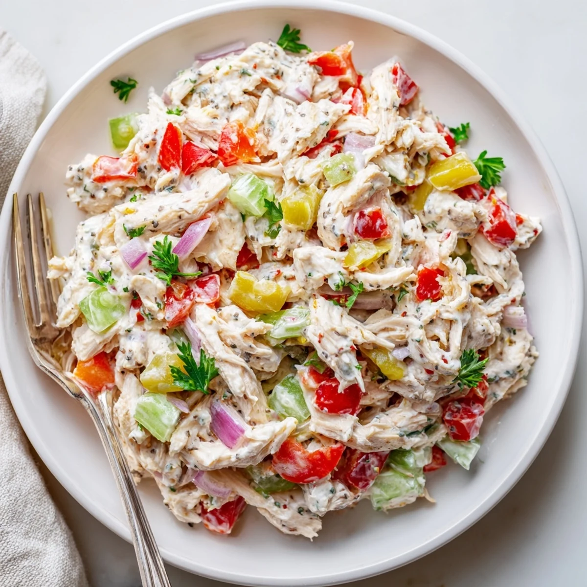 High Protein Pepperoncini Chicken Salad: shredded chicken, tangy pepperoncini, crunchy celery on plate