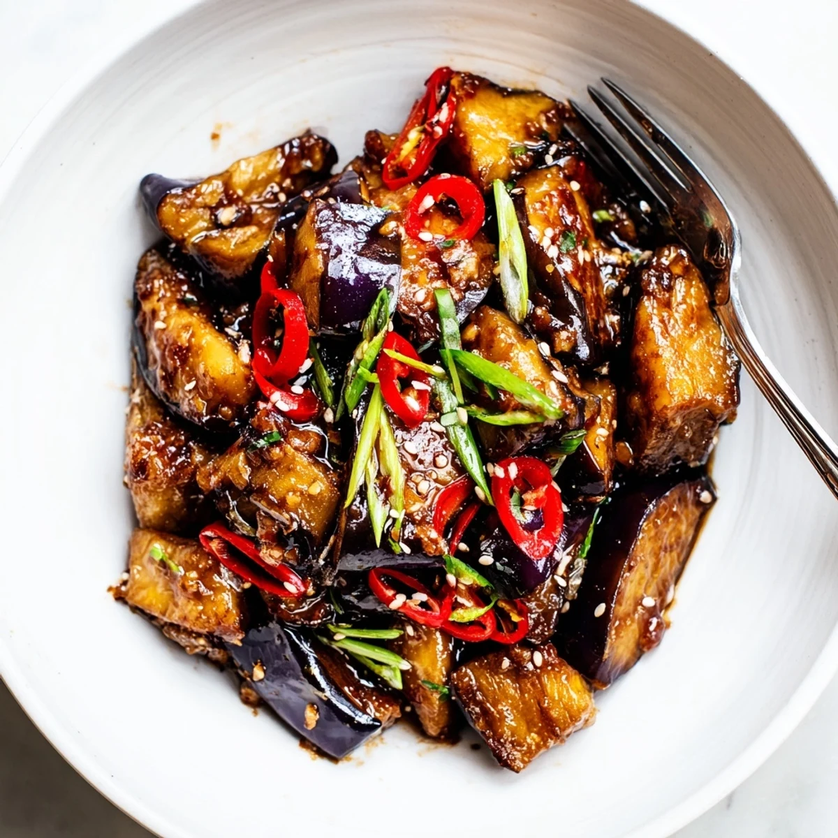 Steaming Sichuan Style Braised Aubergines scented with garlic, ginger, sliced scallions.
