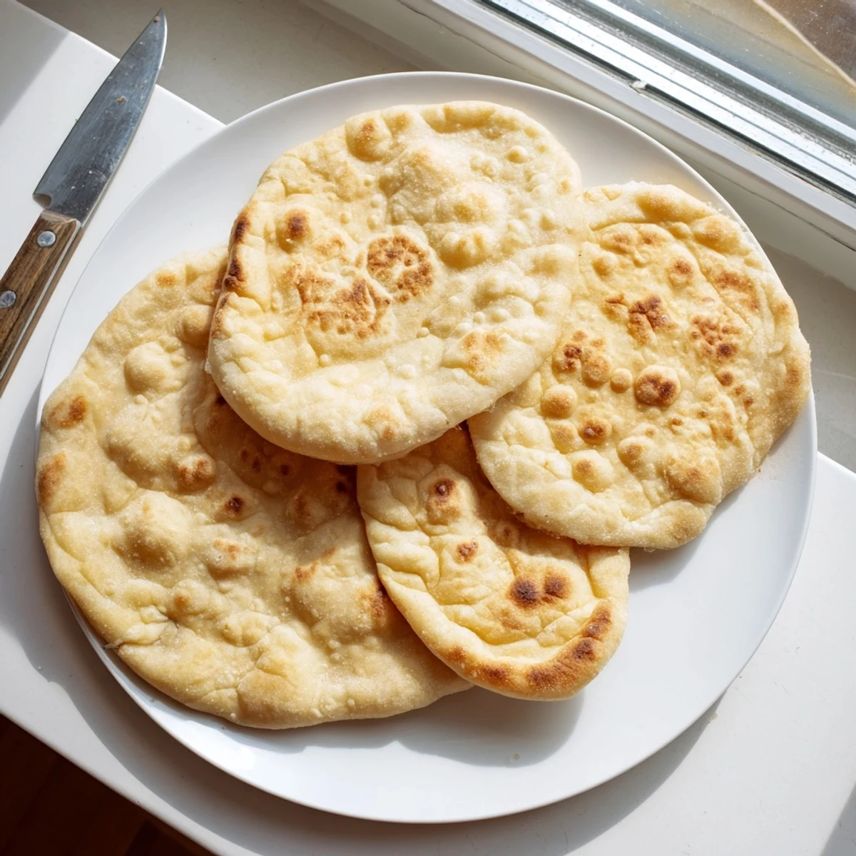Soft homemade Turkish Bazlama bread warm from skillet with golden charred spots