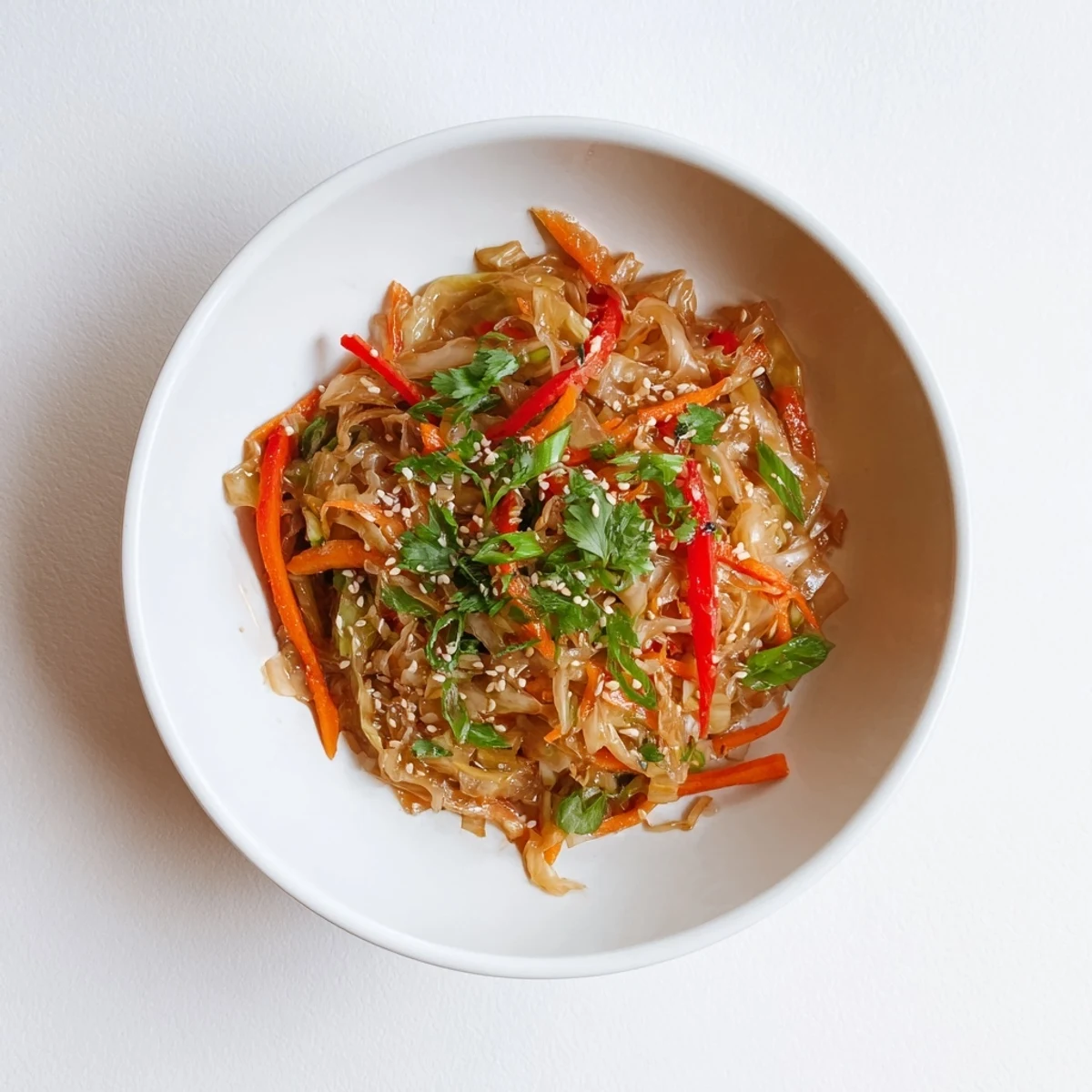Colorful cabbage stir fry featuring crisp green cabbage, bell peppers, and carrots in a savory sesame soy sauce