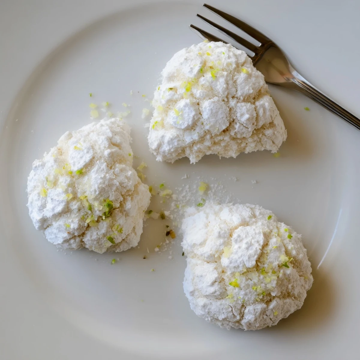 Tropical Coconut Key Lime Crinkle Cookies with powdered sugar and zesty lime  