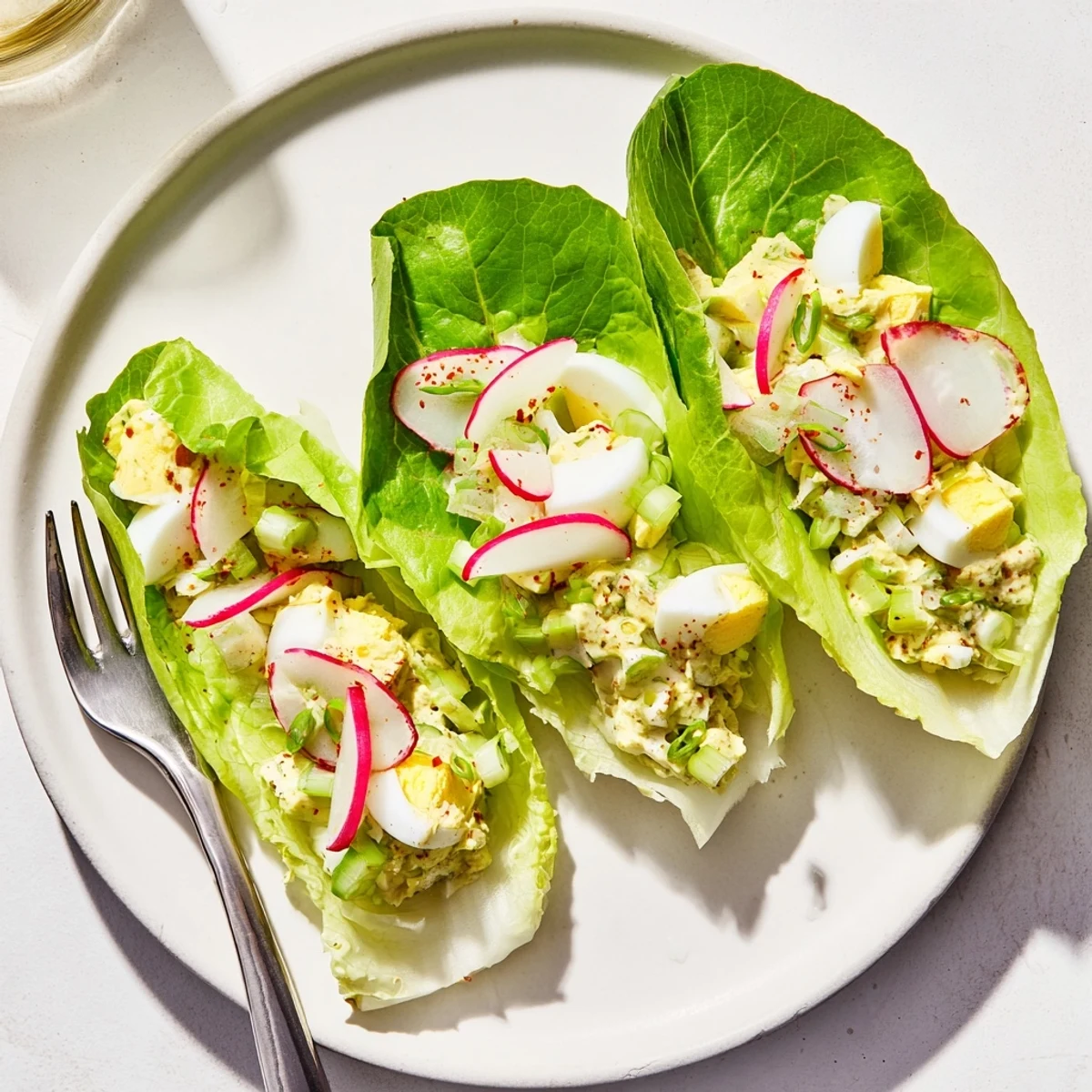 Crisp butter lettuce holding Egg Salad Lettuce Wraps with crunchy celery