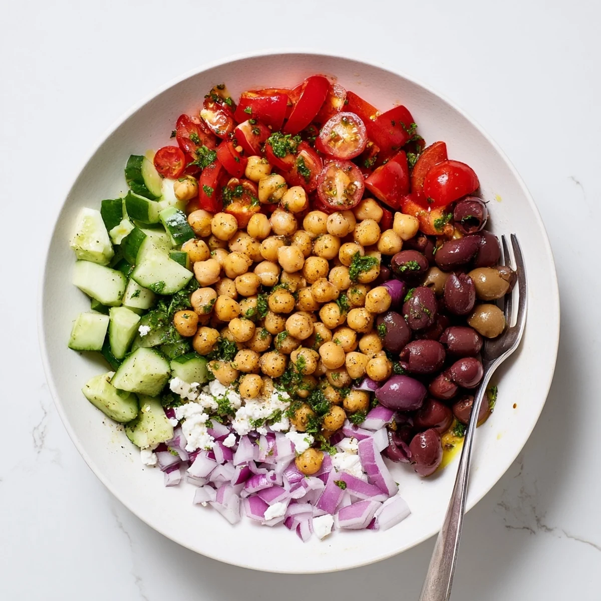 Vibrant Mediterranean Chickpea Delight served chilled, sprinkled with crumbled feta and parsley