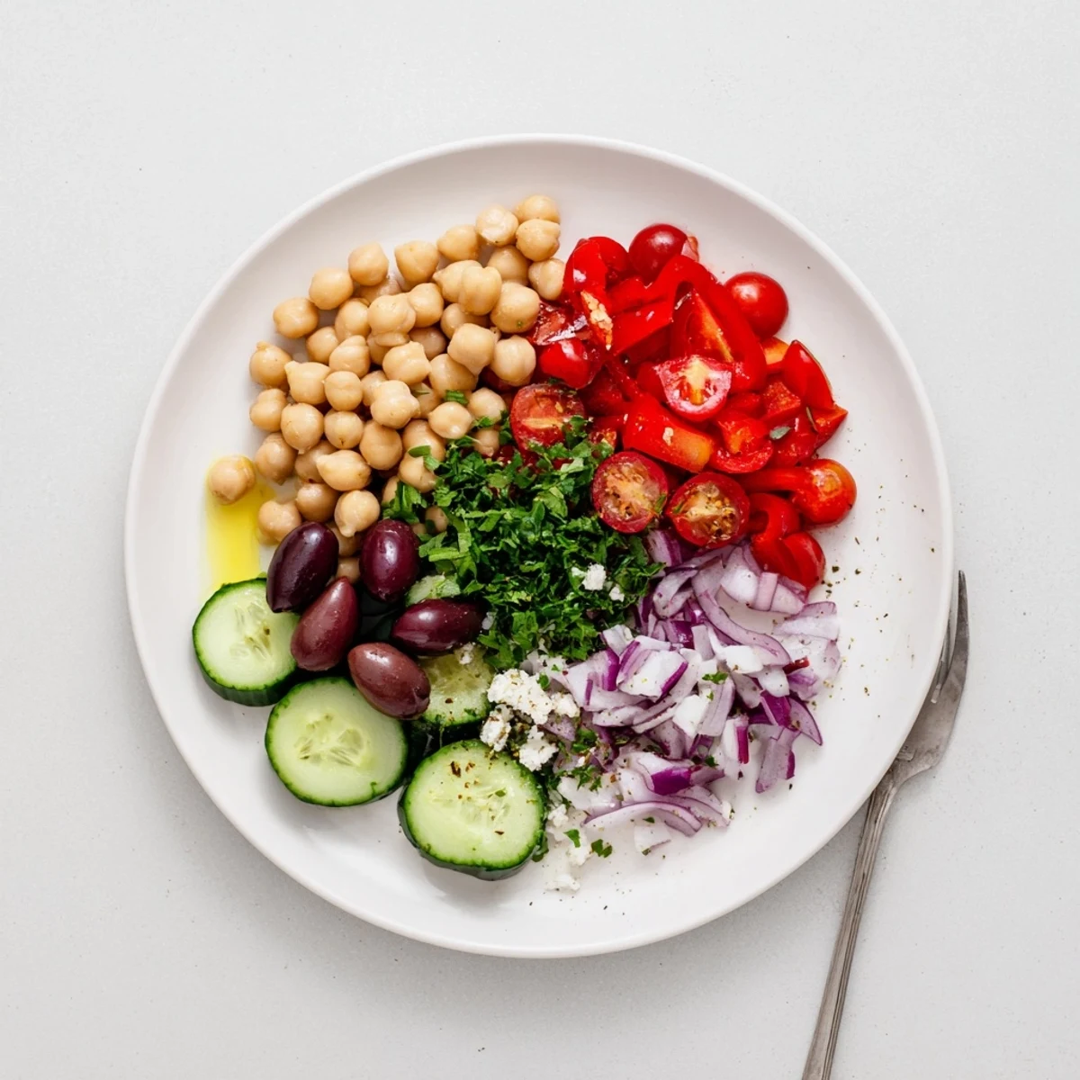Vibrant Mediterranean Chickpea Delight tossed in bowl, colorful tomatoes, olives, ready to eat