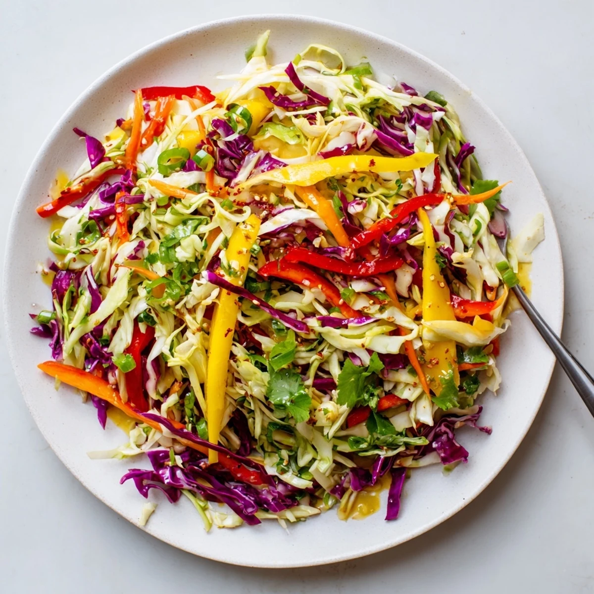 Piled in a bowl, Mango Cabbage Citrus Slaw shows bright colors  