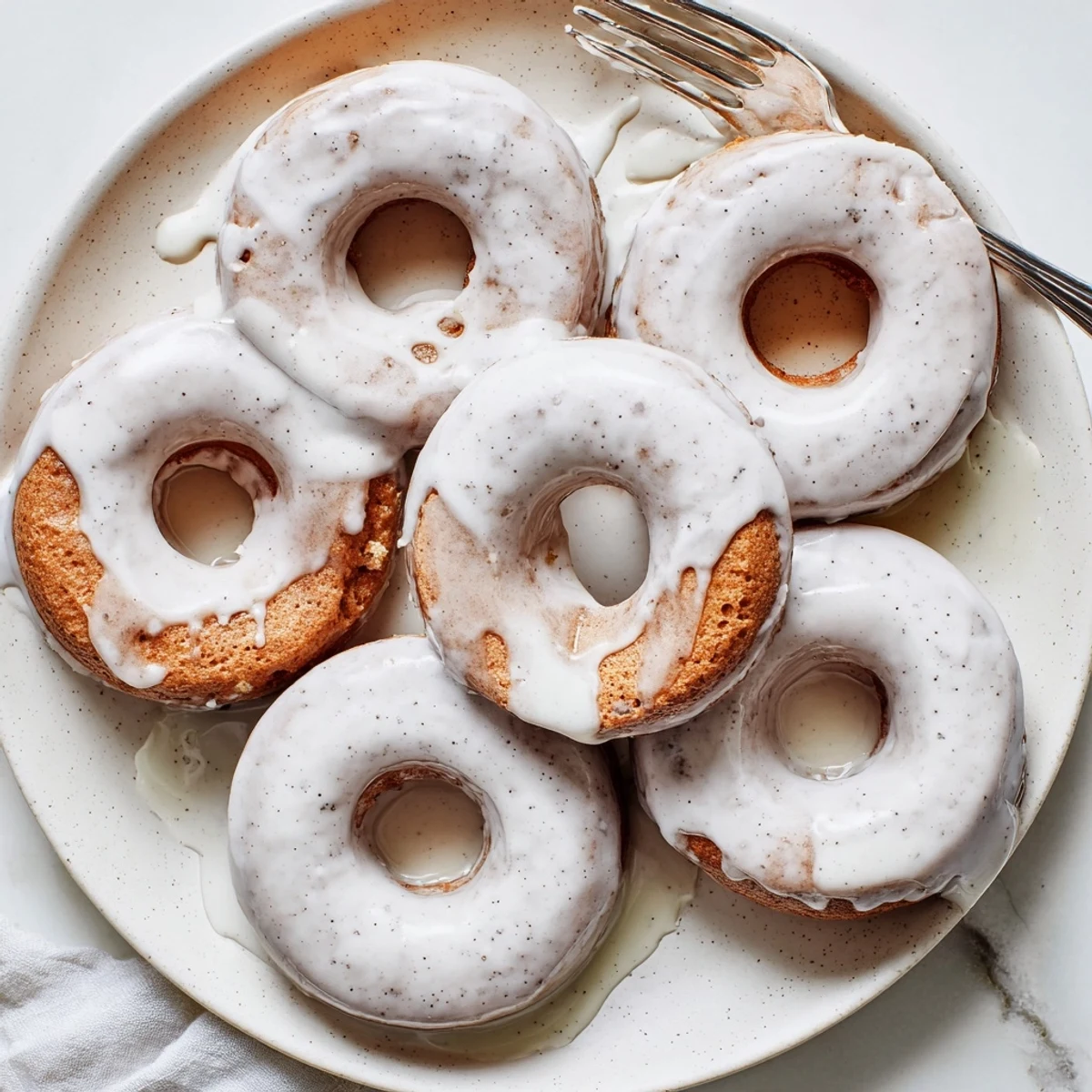 Moist baked banana bread donuts dusted with powdered sugar ready for breakfast