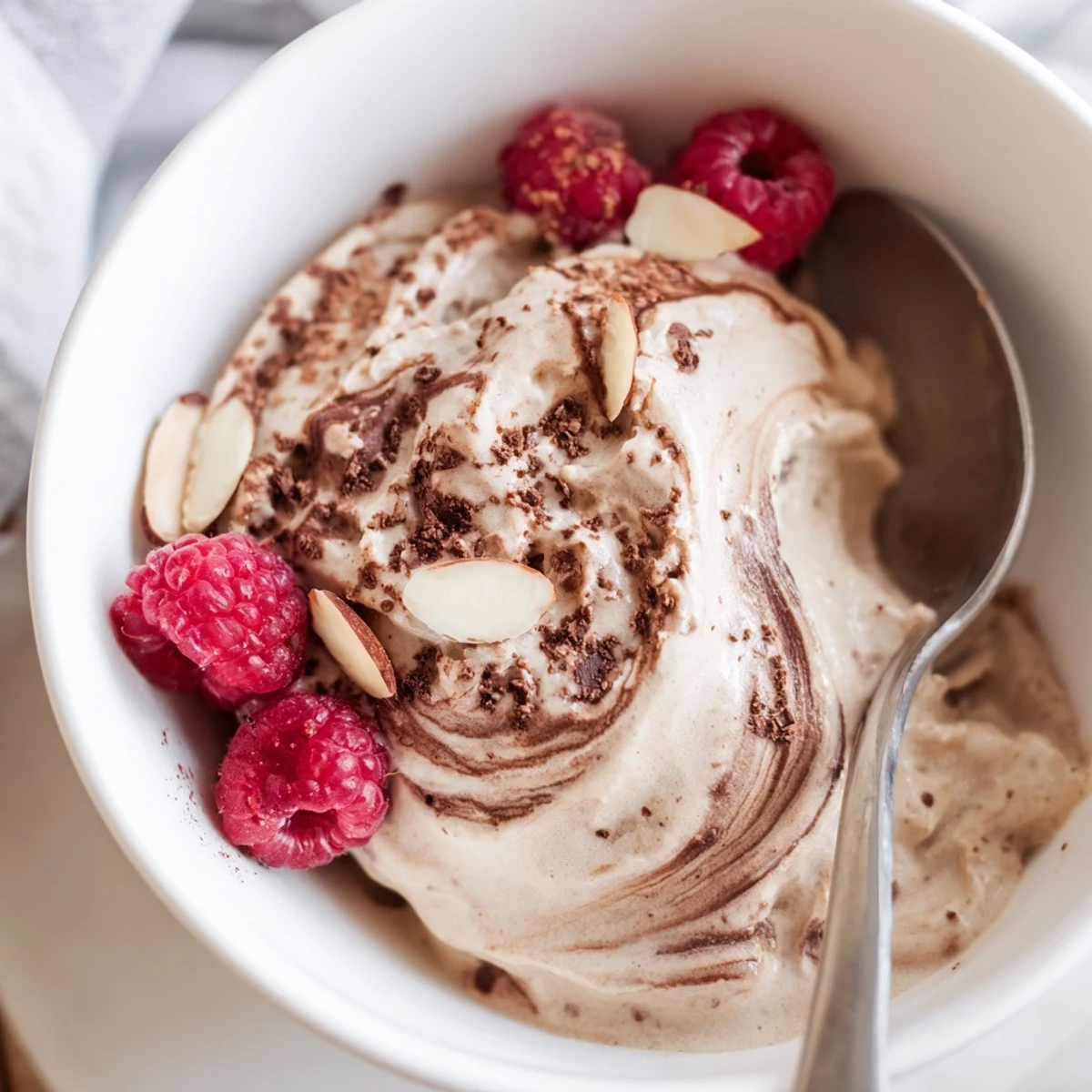 Creamy healthy nice cream recipe swirled in bowls topped with fresh berries and dark chocolate shavings