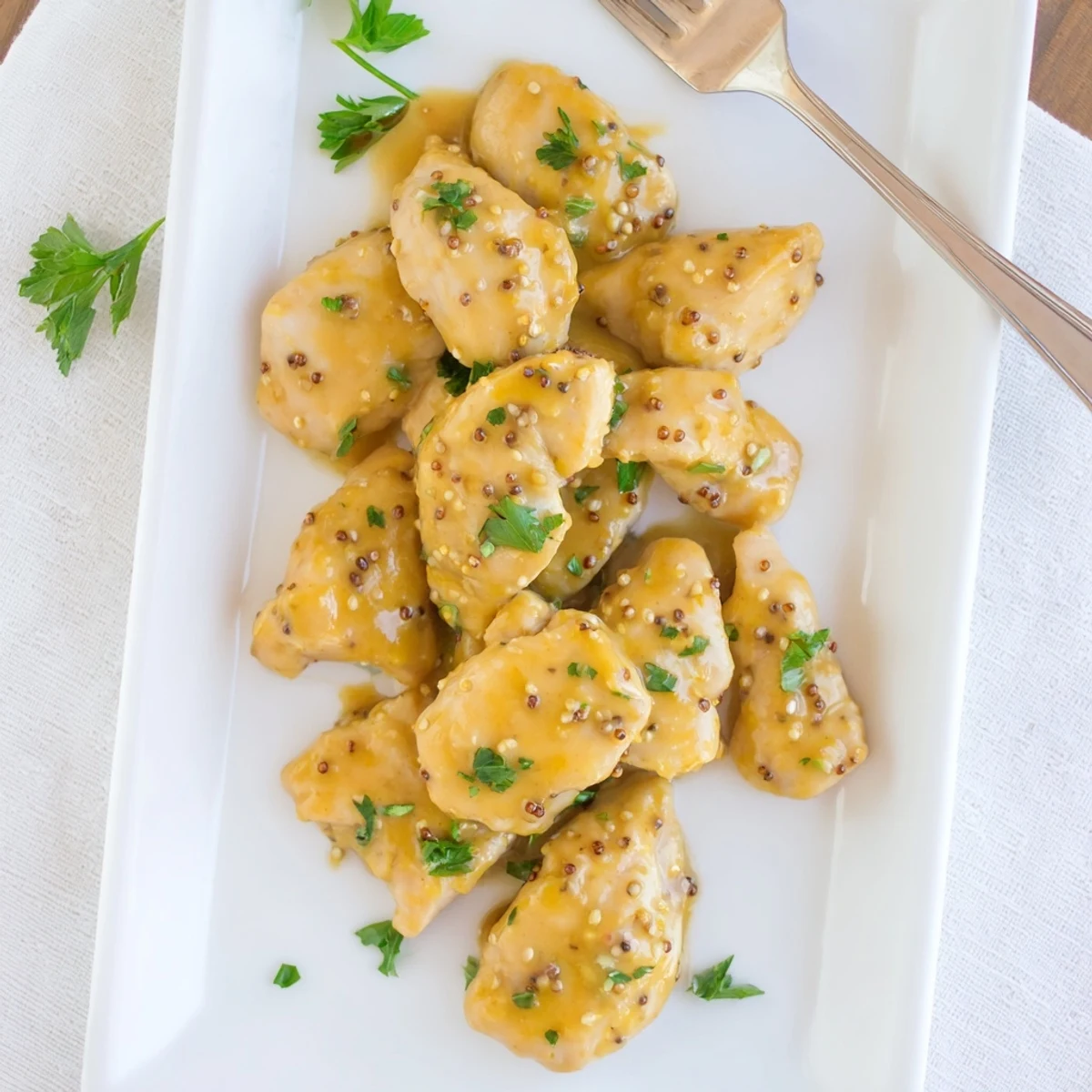 Family style baked honey mustard chicken dinner with tender meat glistening under tangy honey mustard glaze