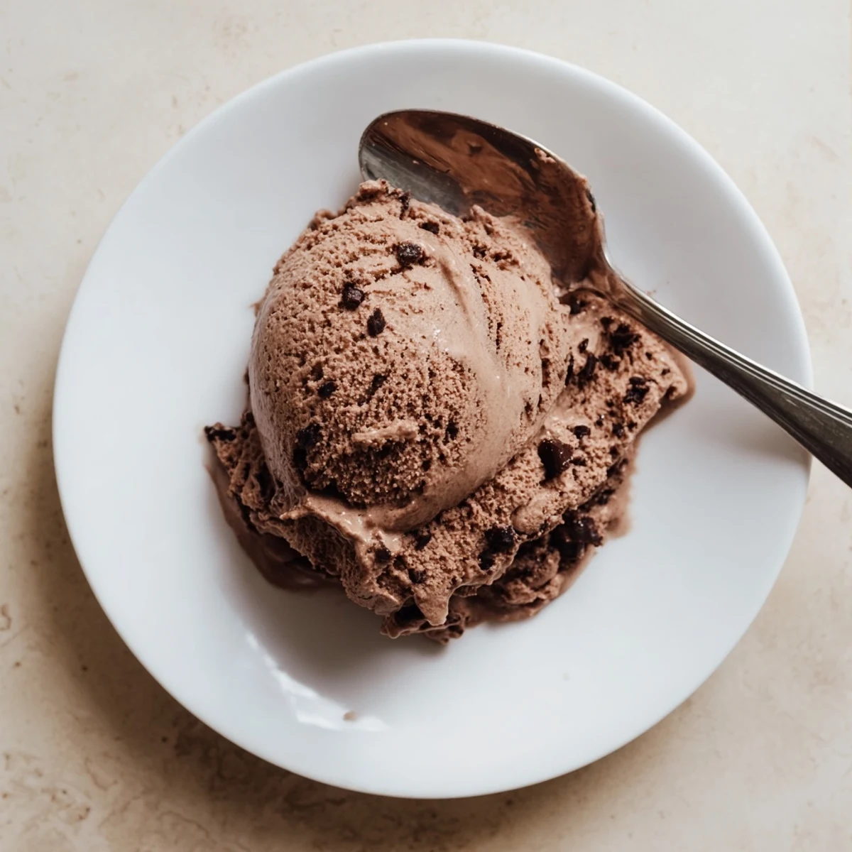 Creamy chocolate sourdough ice cream scooped into a bowl with dark chocolate shavings on top