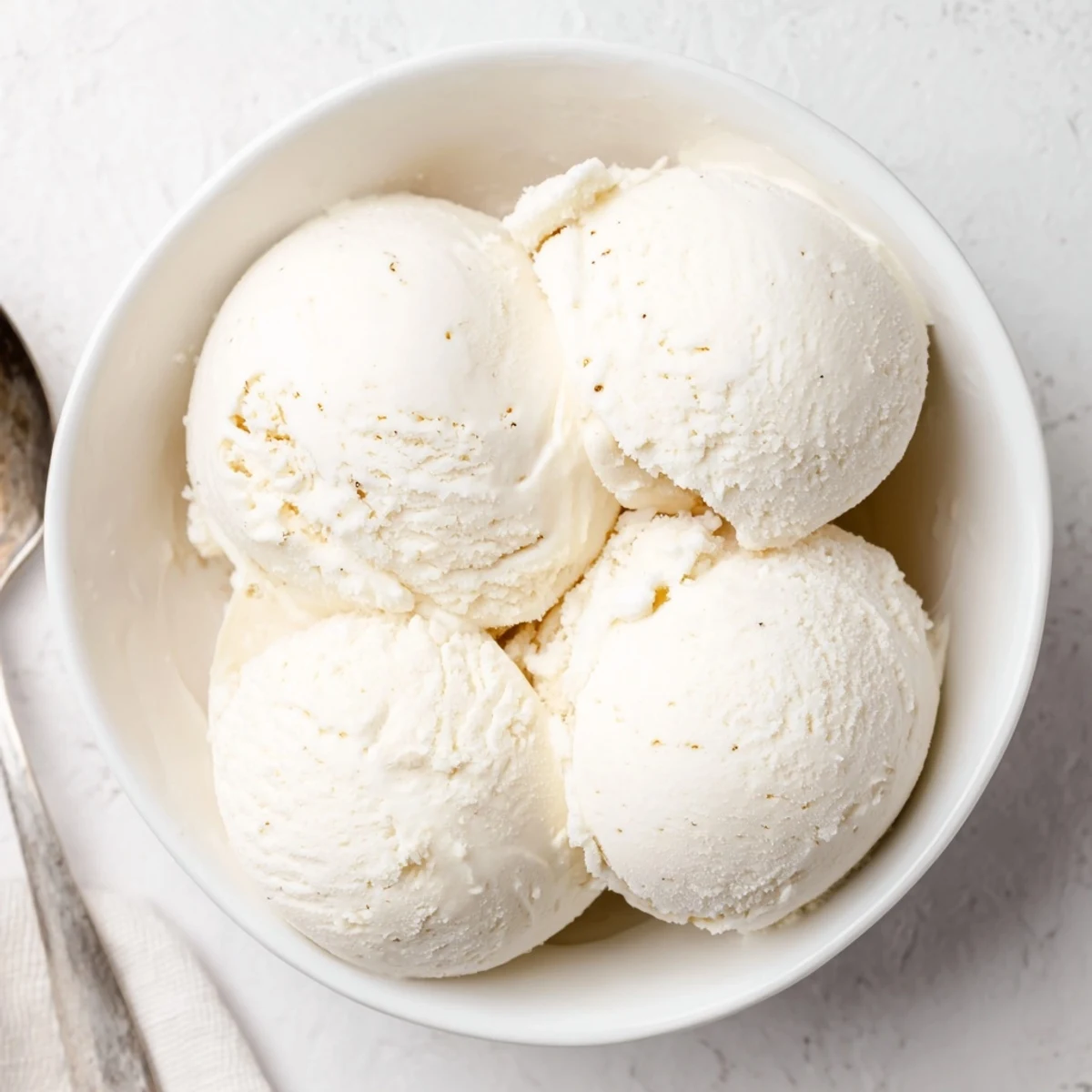 Velvety smooth vanilla ice cream dessert served in a vintage ceramic bowl with elegant garnish