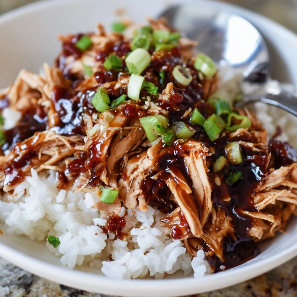 Family-style Crockpot Honey Garlic Chicken topped with green onions, perfect weeknight dinner
