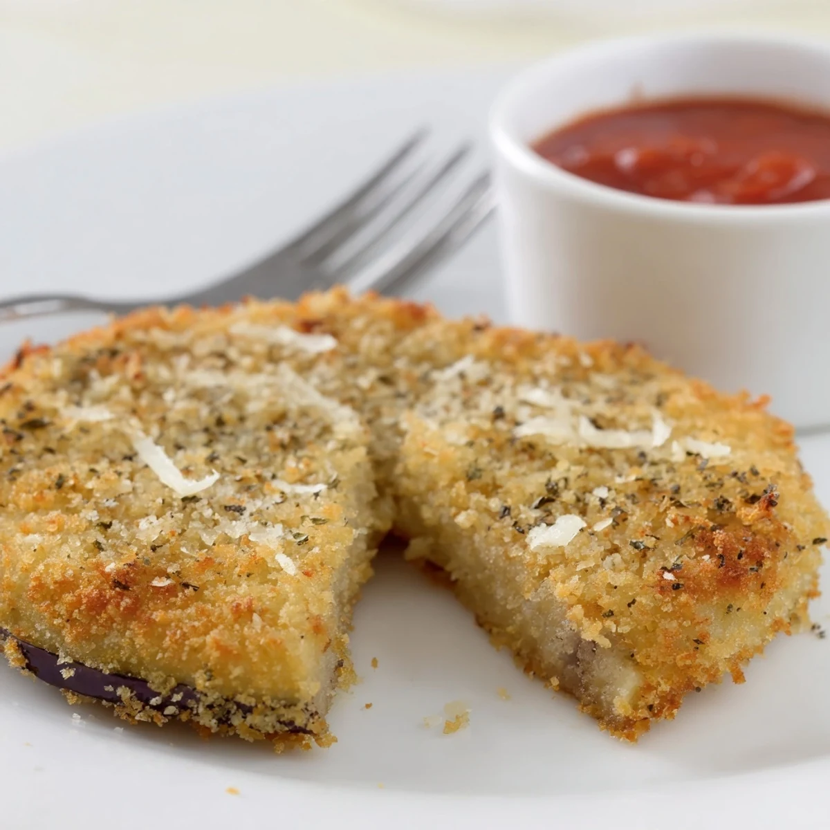 Warm Crispy Baked Eggplant rounds, herb-scented and perfect atop toasted sandwich