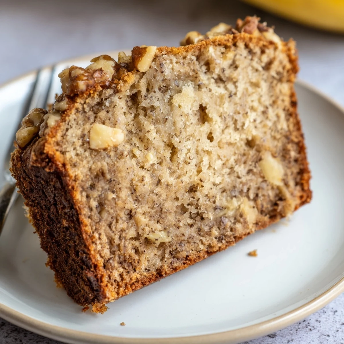 Sliced Moist Banana Cake served with coffee, tender crumb and cinnamon.