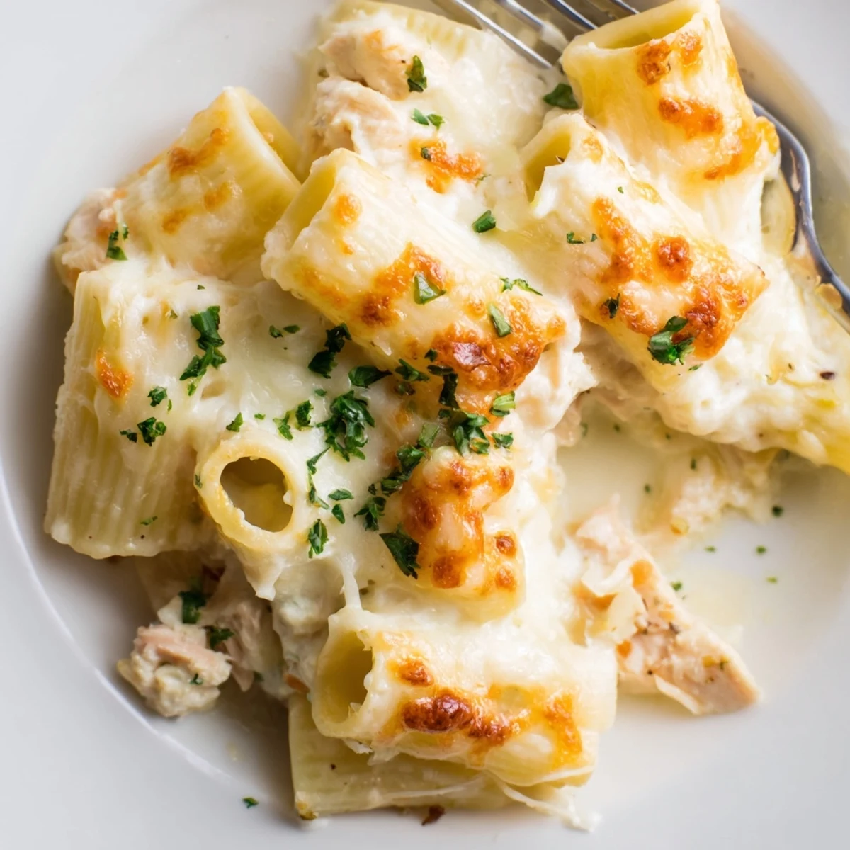 Oven-browned Creamy Chicken Alfredo Bake With Mozzarella Crust, creamy sauce oozing, slice ready