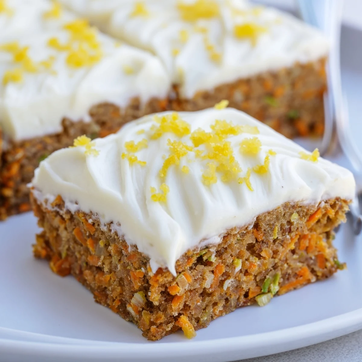 Freshly sliced Spiced Ginger Carrot And Zucchini Bars With Lemon Cream Cheese Frosting