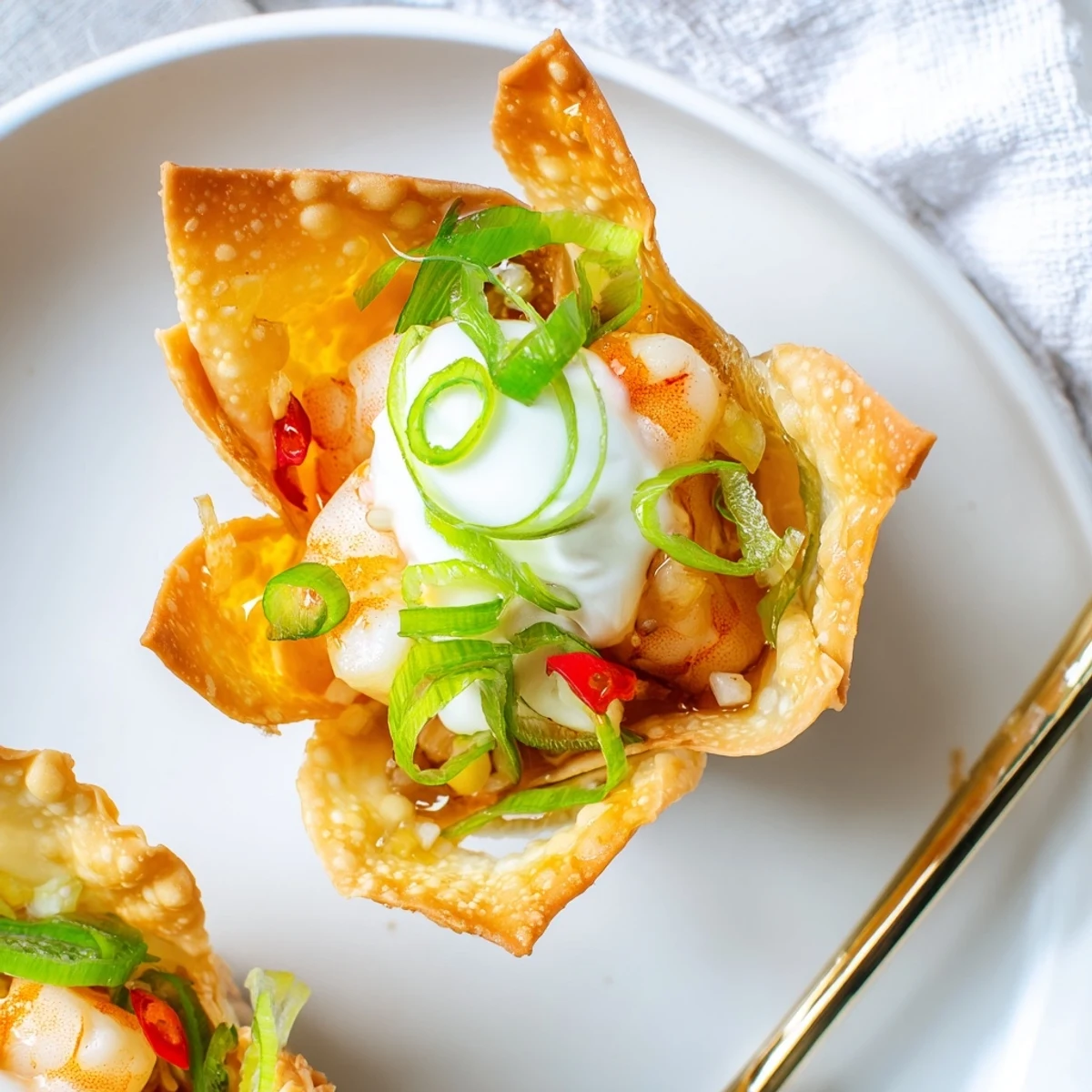 Warm Crispy Shrimp Wonton Cups With Lime Cream topped with cilantro and zest.