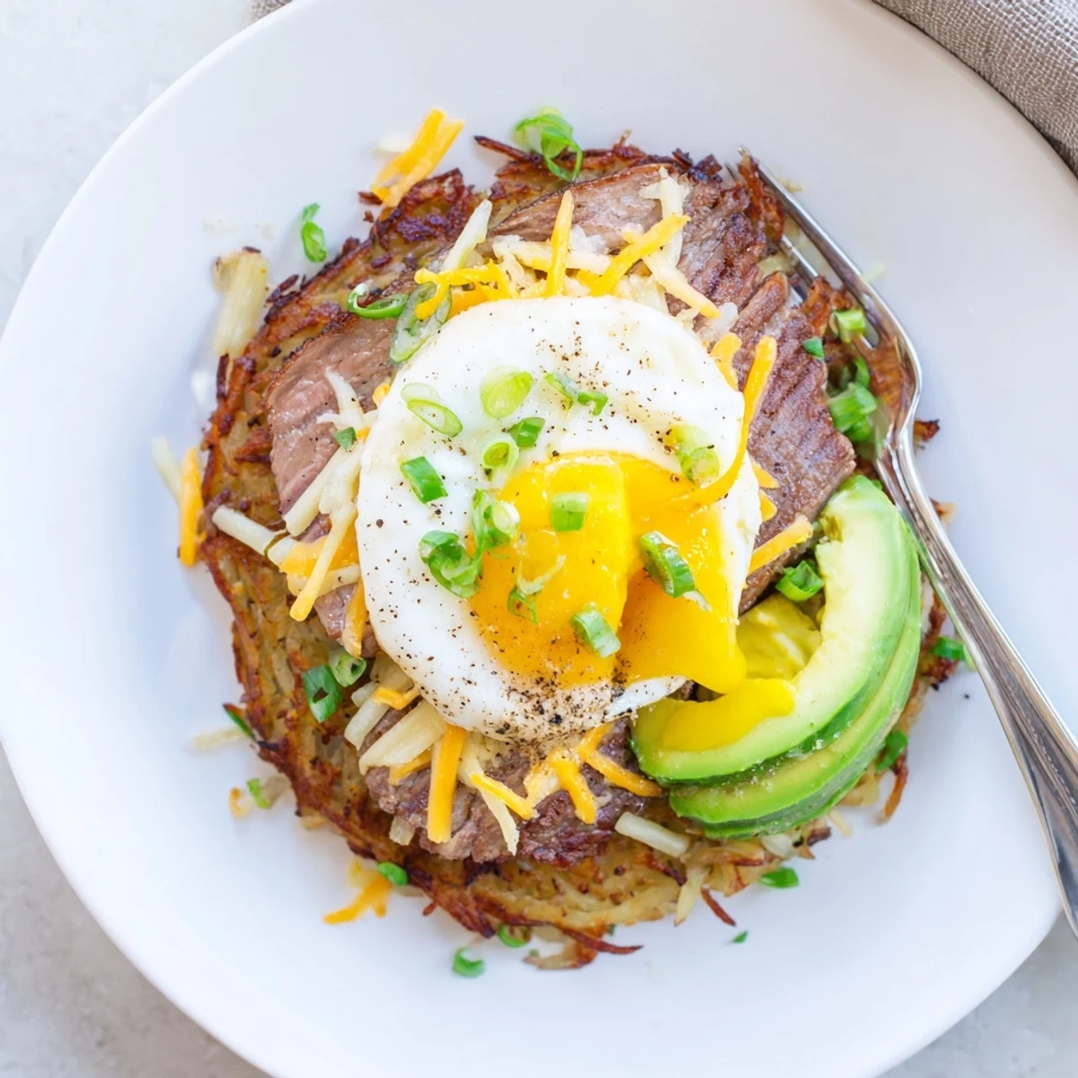 Loaded Steak Egg Hash Brown Stacks Recipe with crispy golden hash browns, juicy steak
