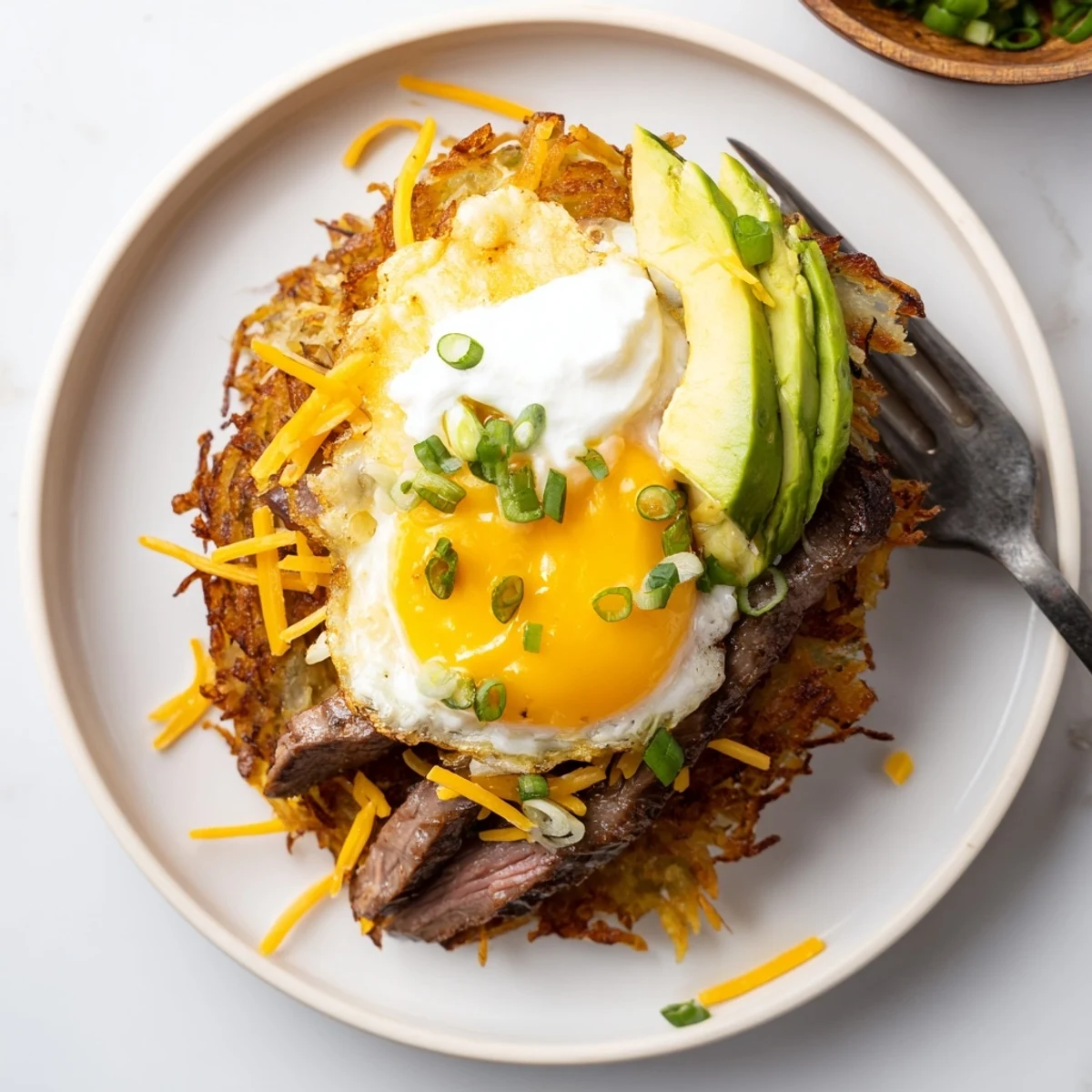 Loaded Steak Egg Hash Brown Stacks Recipe, ideal weekend brunch served with sour cream