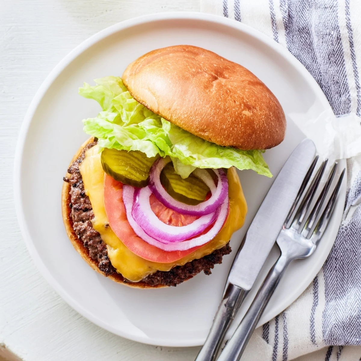 Juicy beef smash burgers melting with American cheese and served on buttery toasted buns