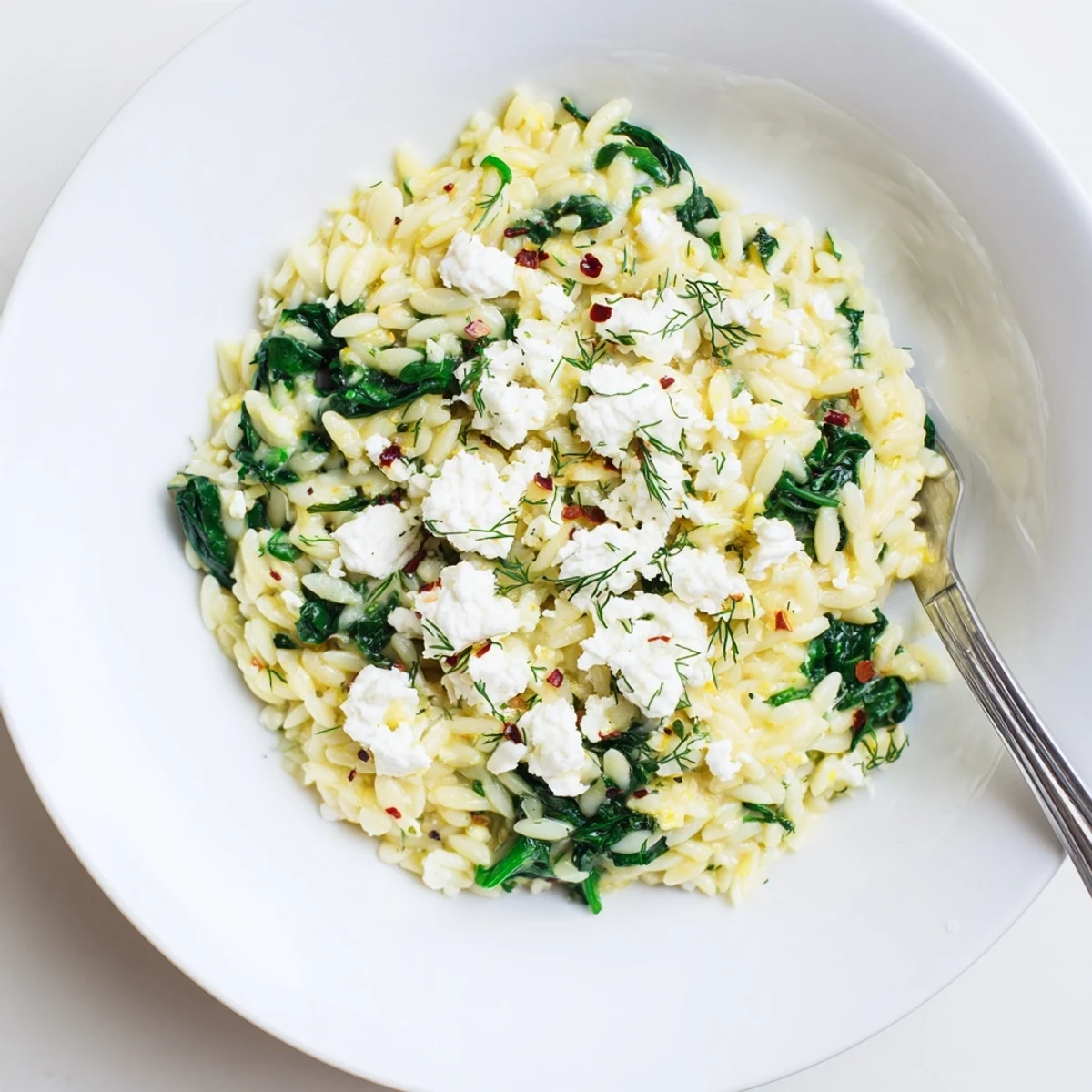 Creamy Mediterranean one pan lemon orzo dotted with white feta and fresh green dill