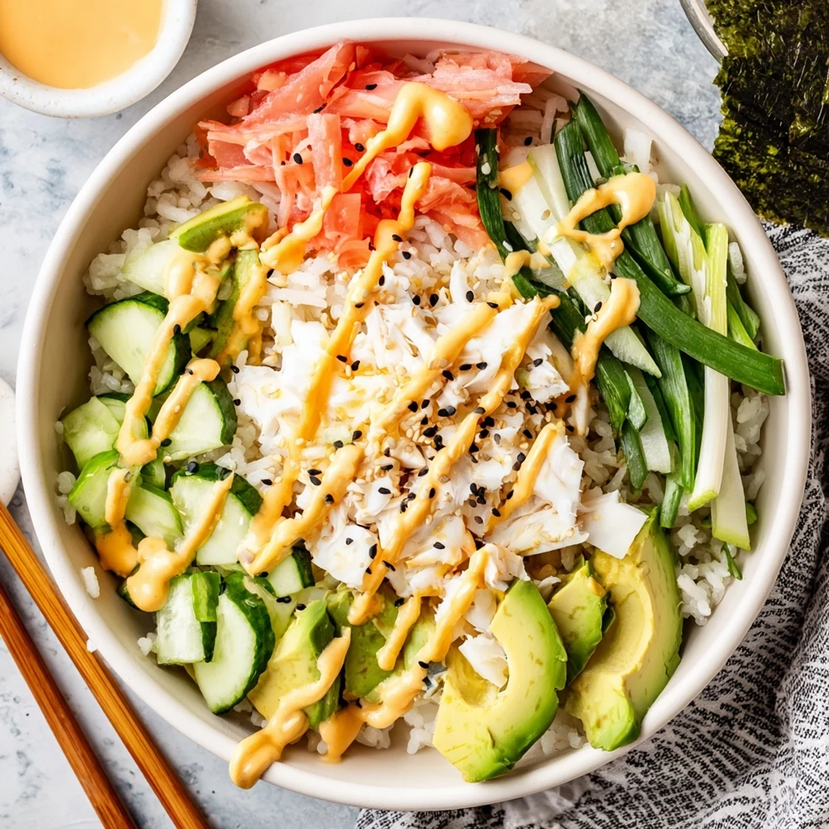 Deconstructed California roll sushi bowl arranged with fresh crab avocado and sesame seeds