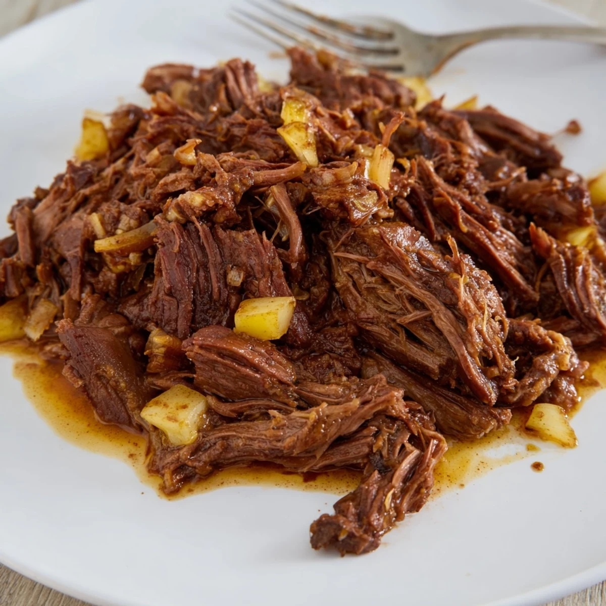 Tender Slow Cooker Beef Barbacoa shredded and served in warm corn tortillas with fresh cilantro