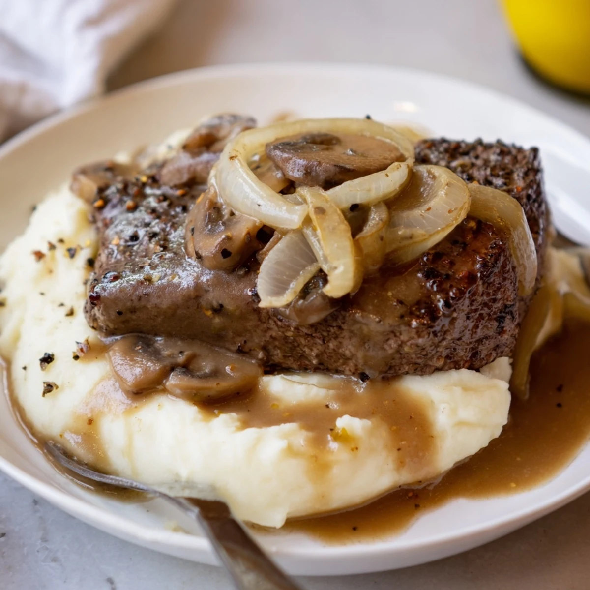 Skillet aroma of Country Style Smothered Cube Steak Recipe with mushrooms and gravy