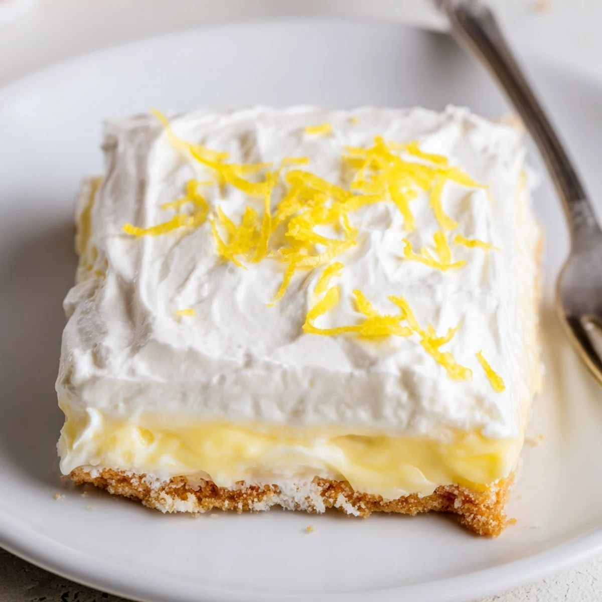 Lightly zested Lemon Lush Cake, tangy pudding center and cloudlike whipped topping