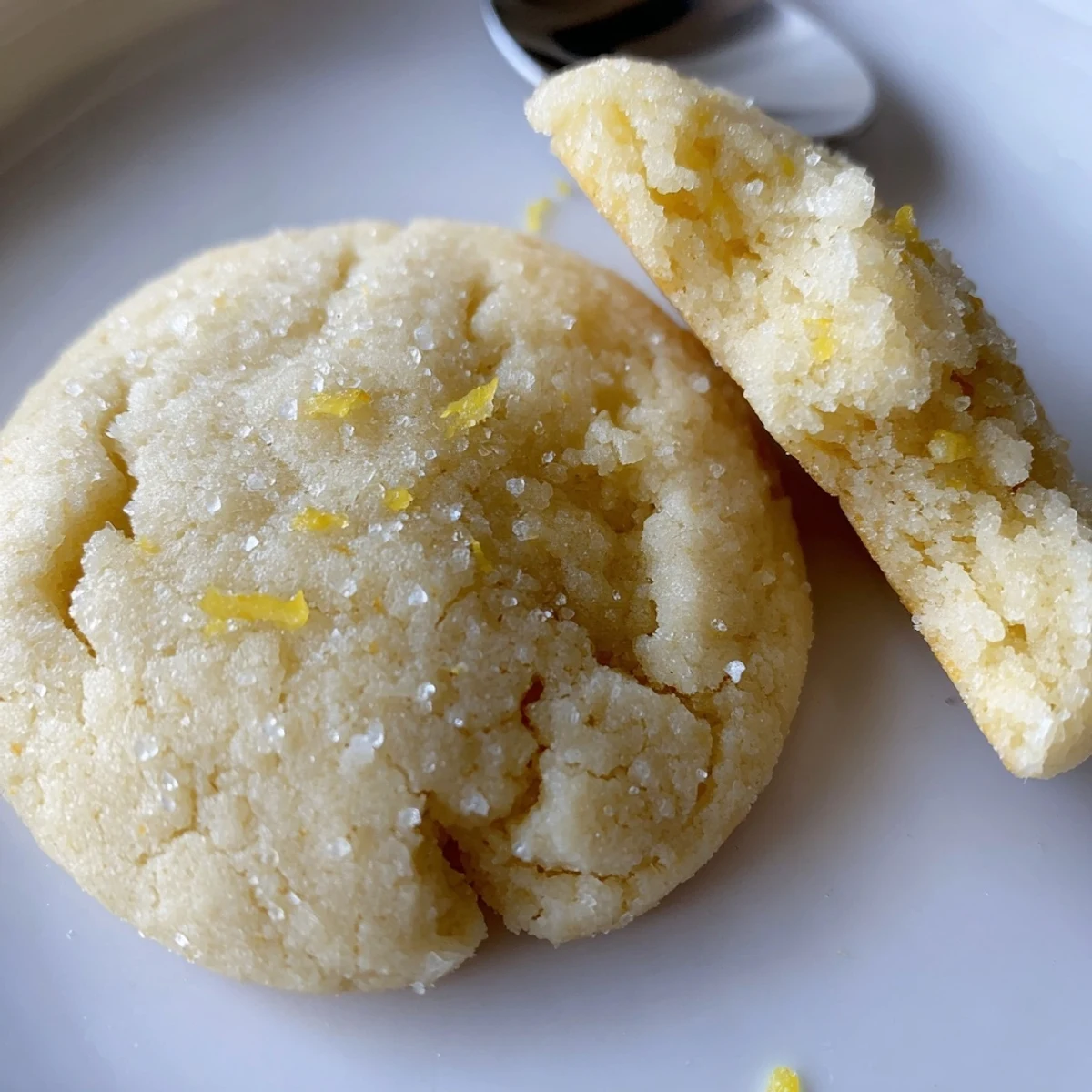 Warm Soft Chewy Lemon Cookies on parchment-lined baking sheet, buttery citrus aroma