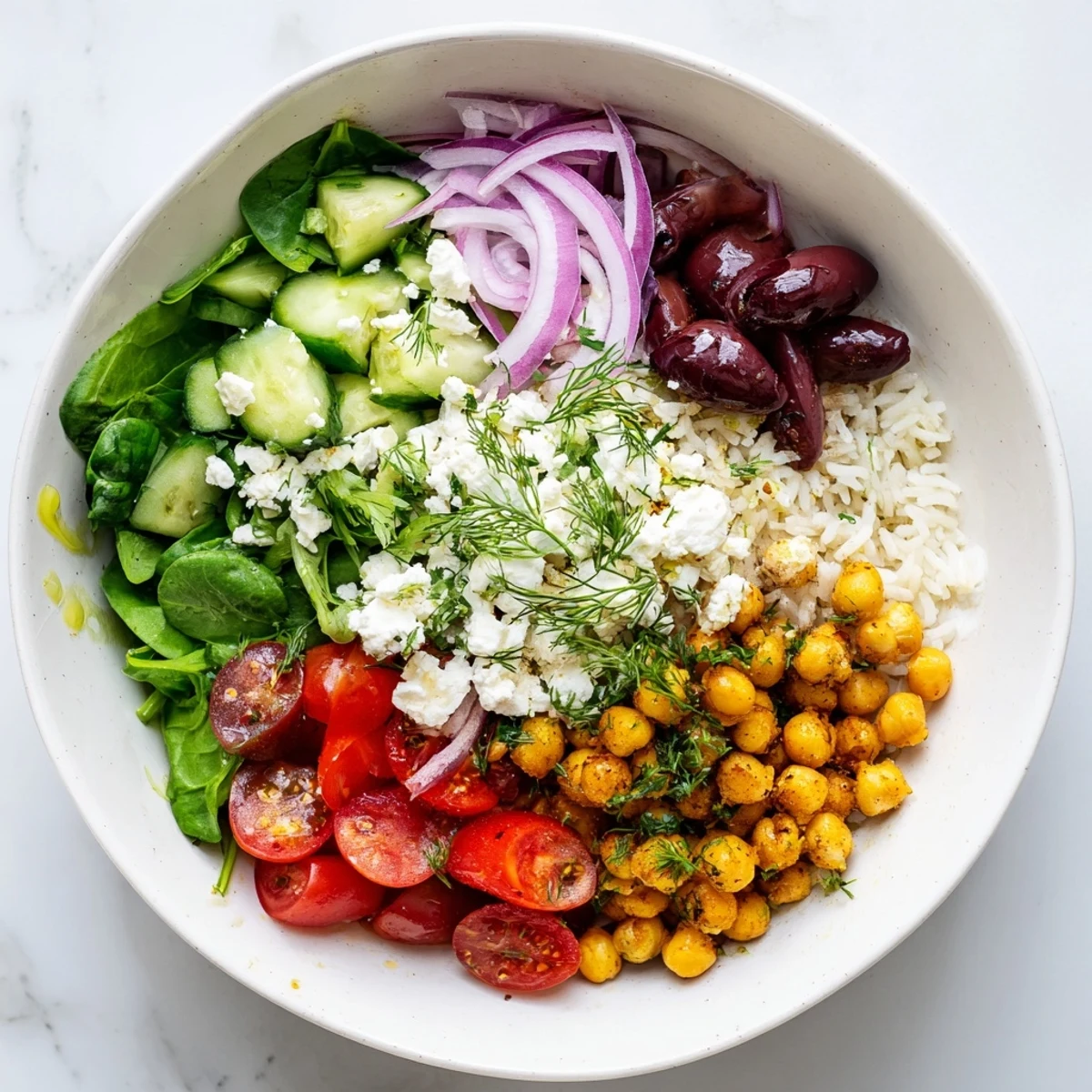 Fluffy rice layered with juicy tomatoes, olives, and feta in this Mediterranean Rice Bowl
