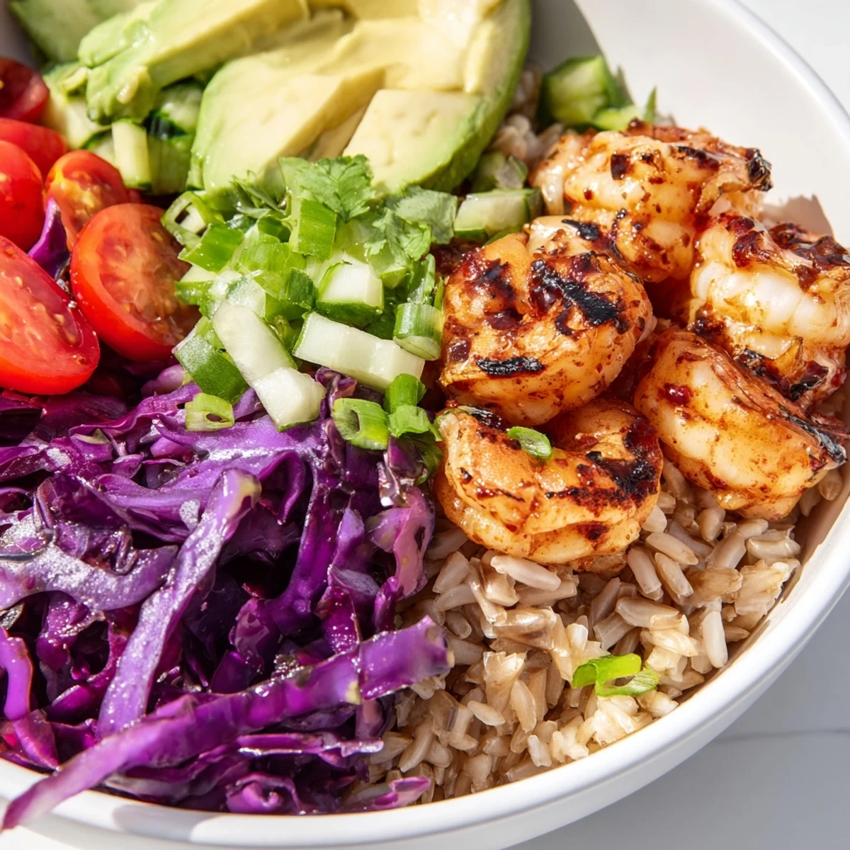 Colorful shrimp grain bowl loaded with crisp vegetables and tender paprika-spiced shrimp