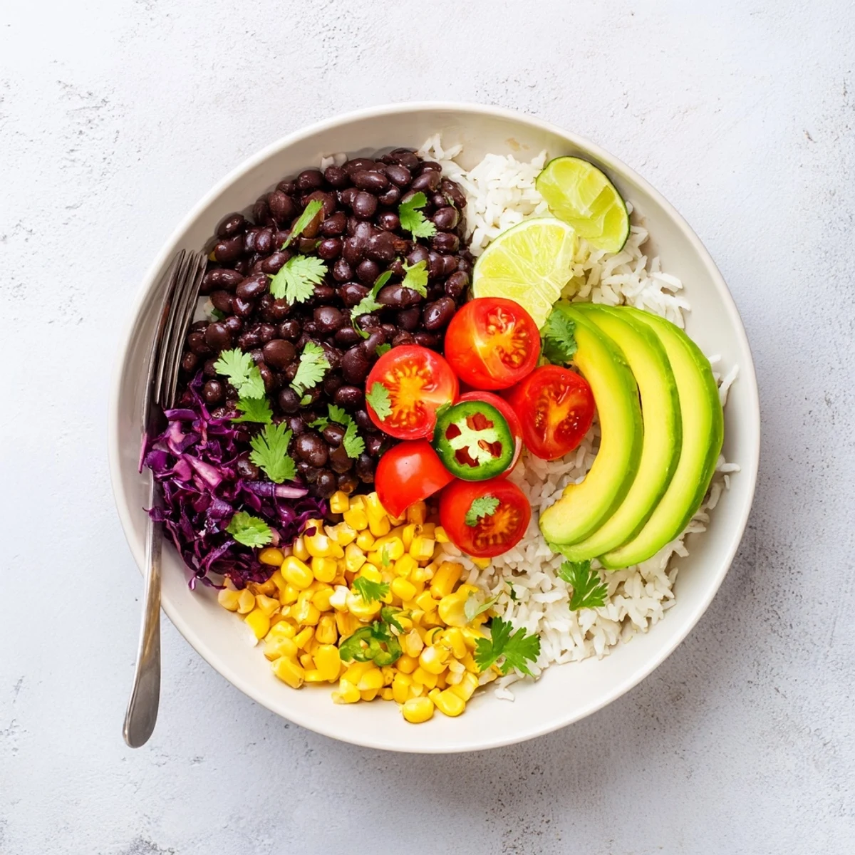Steaming black bean and rice bowl served in a rustic dish with vibrant vegetables