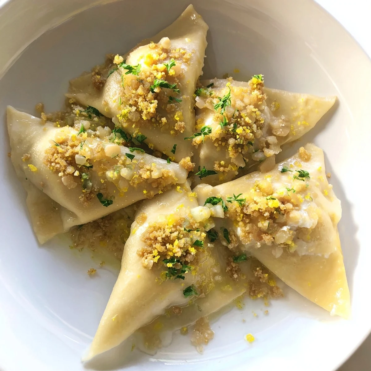 Golden leek burrata triangoli draped in lemon butter sauce with crispy breadcrumbs