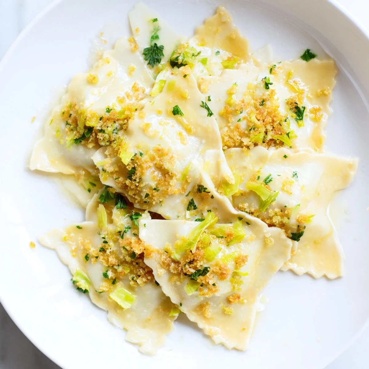 Steaming leek burrata triangoli tossed in tangy lemon butter and sprinkled with crunchy crumbs