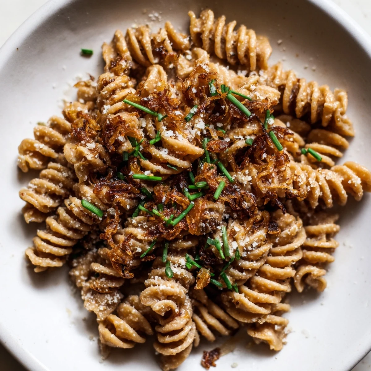Brown Butter Miso Roasted Garlic Radiatori tossed in a glossy, nutty sauce with crispy golden shallots on top