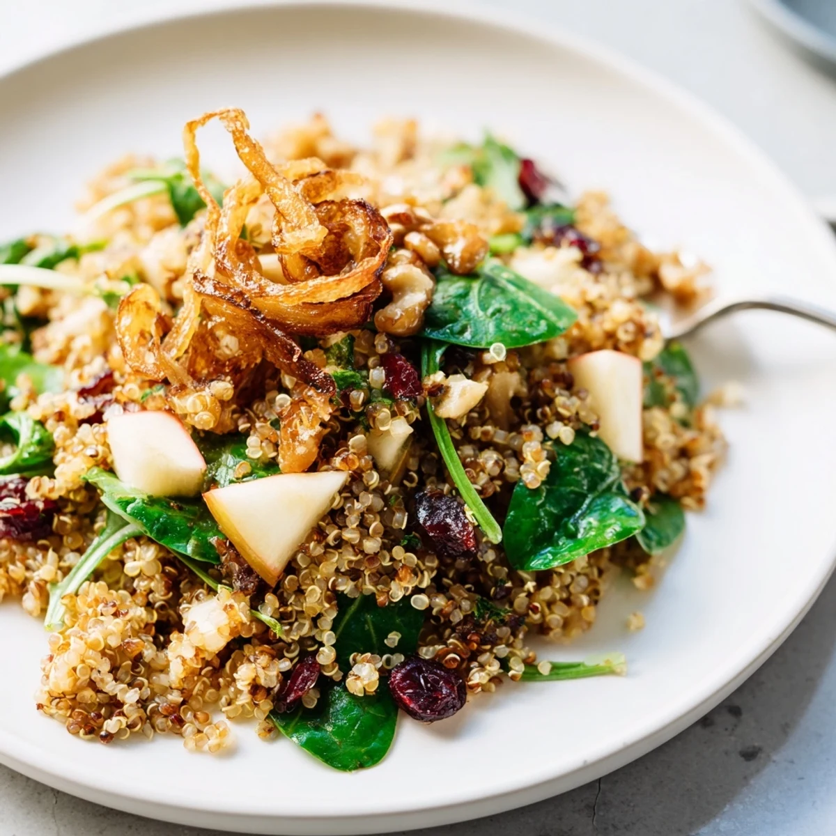 Tangy Honey Mustard Quinoa Apple Salad drizzled with creamy dressing and topped with crunchy shallots