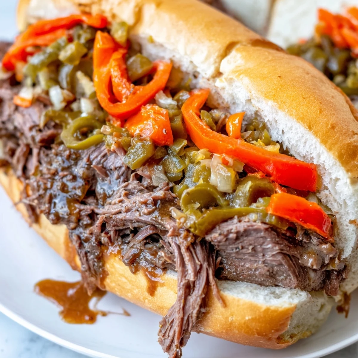 Tender Chicago Style Italian Beef dripping with savory au jus and topped with sweet peppers