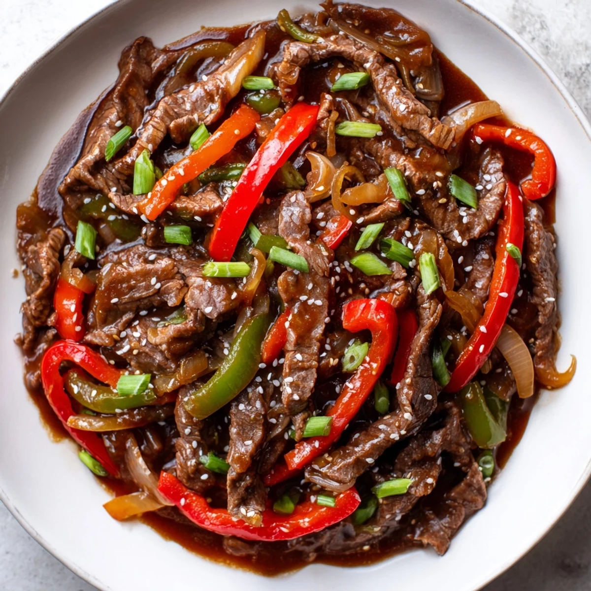 Tender beef strips and vibrant bell peppers in Slow Cooker Pepper Steak served over fluffy white rice