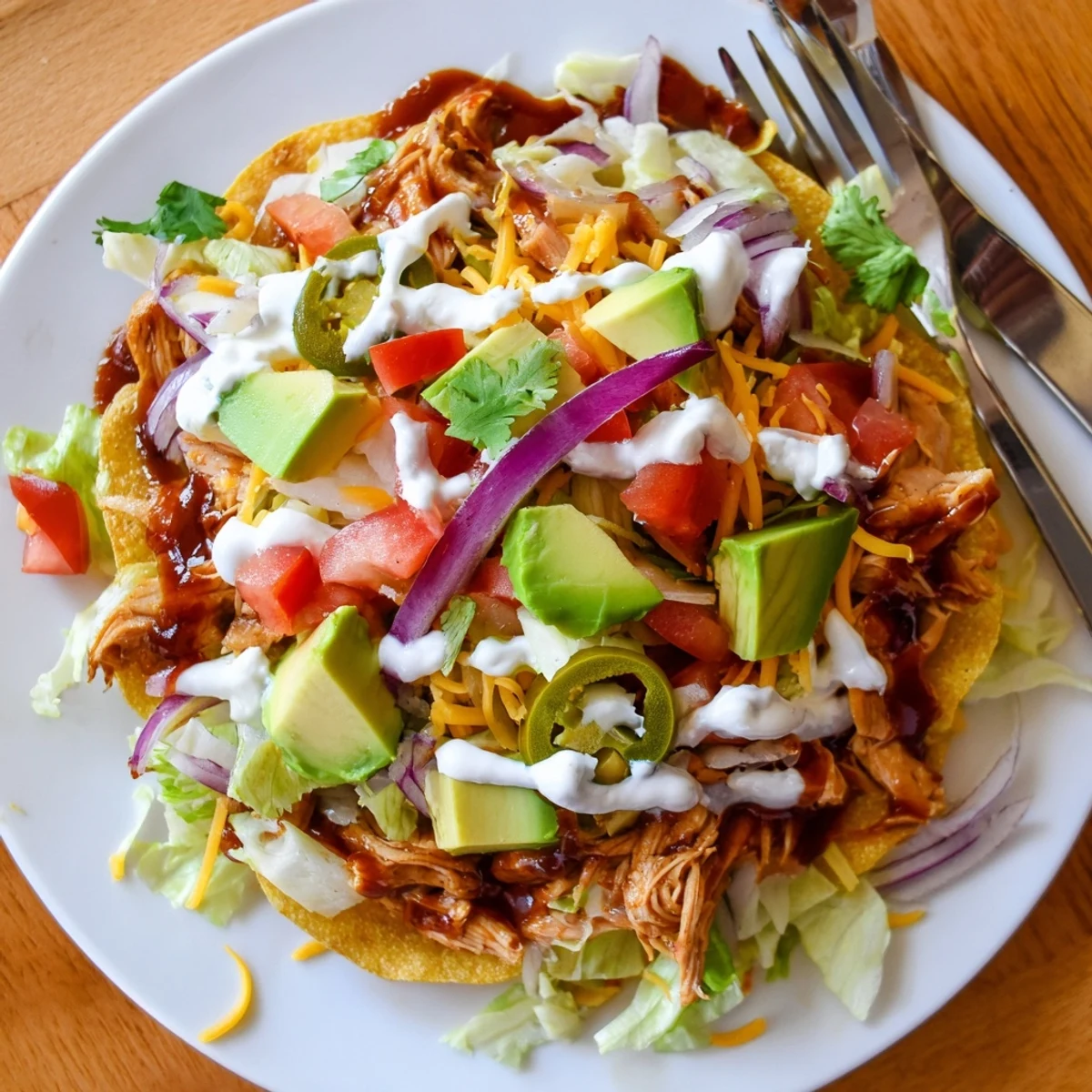 Golden tostada shells piled high with tender sweet smoky BBQ chicken and melted cheddar cheese