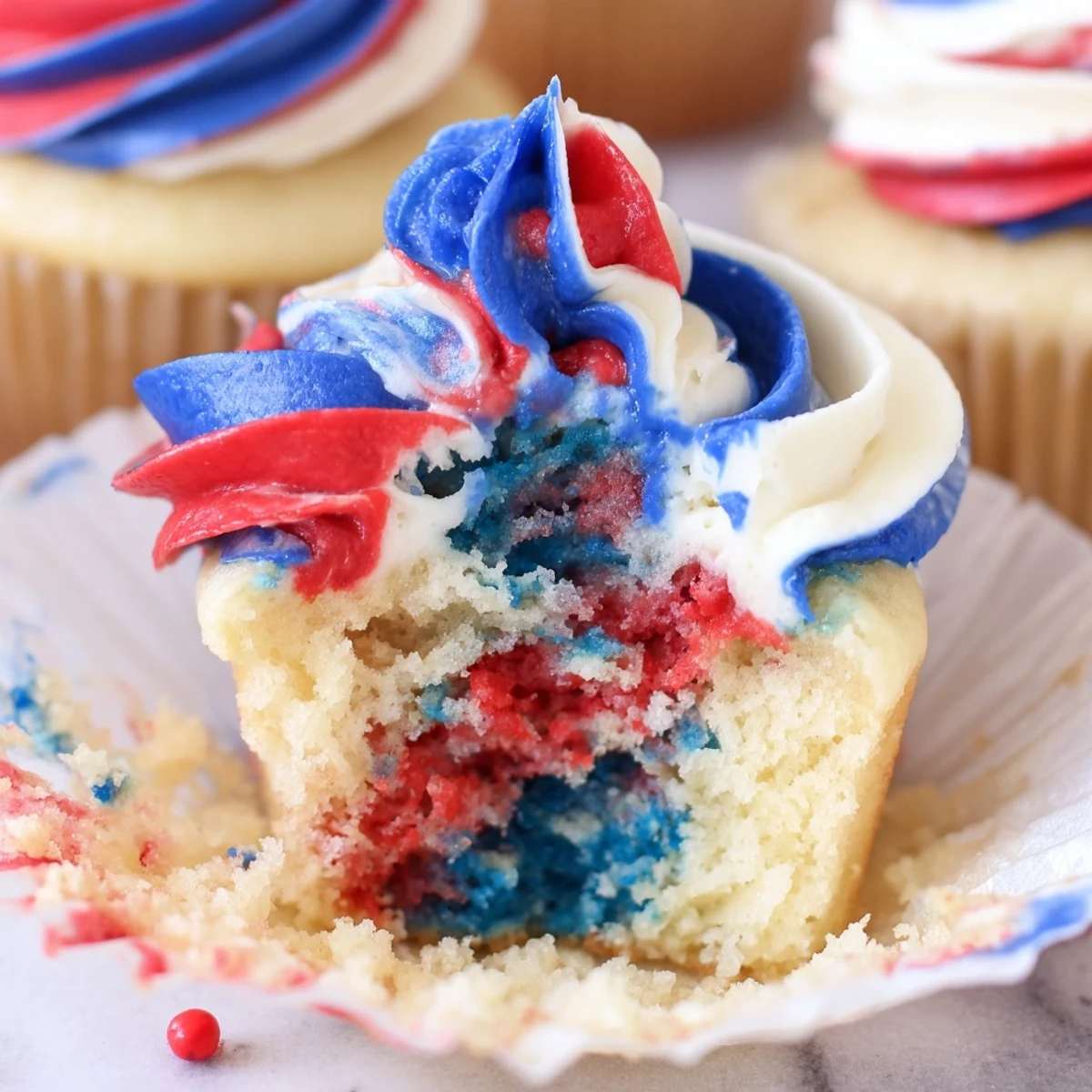 Festive Fourth of July tie dye cupcakes with red white and blue swirls  