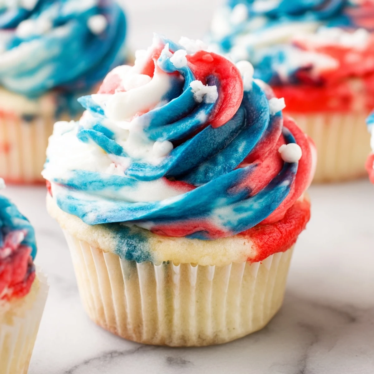 Moist vanilla tie dye cupcakes featuring vibrant red white and blue layers