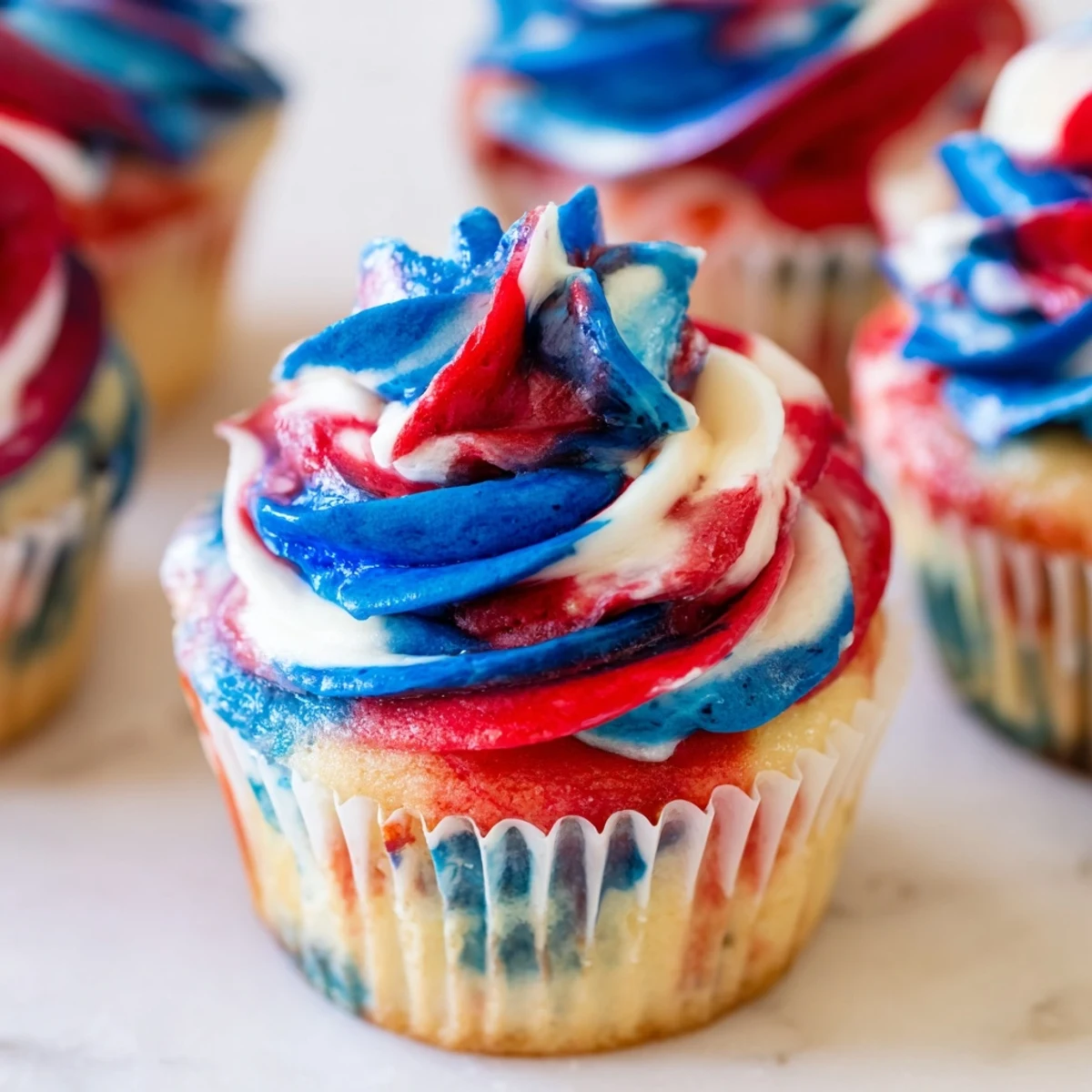 Colorful tie dye cupcakes topped with swirled buttercream for a patriotic celebration  
