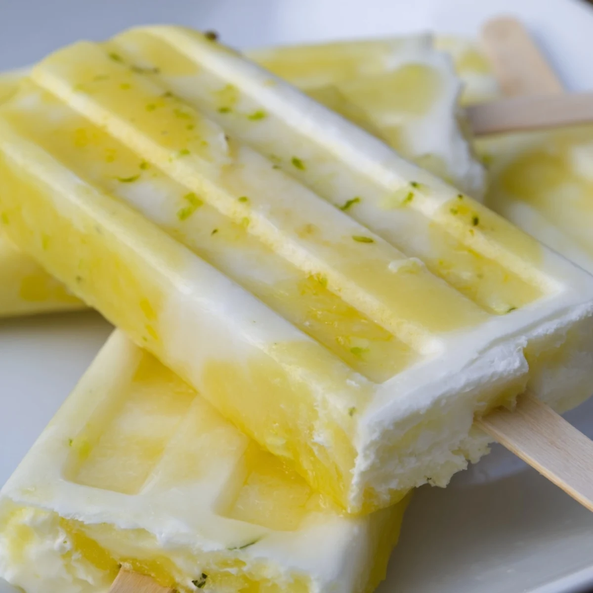 Tropical vegan popsicles layered with sweet pineapple and zesty coconut lime flavor  